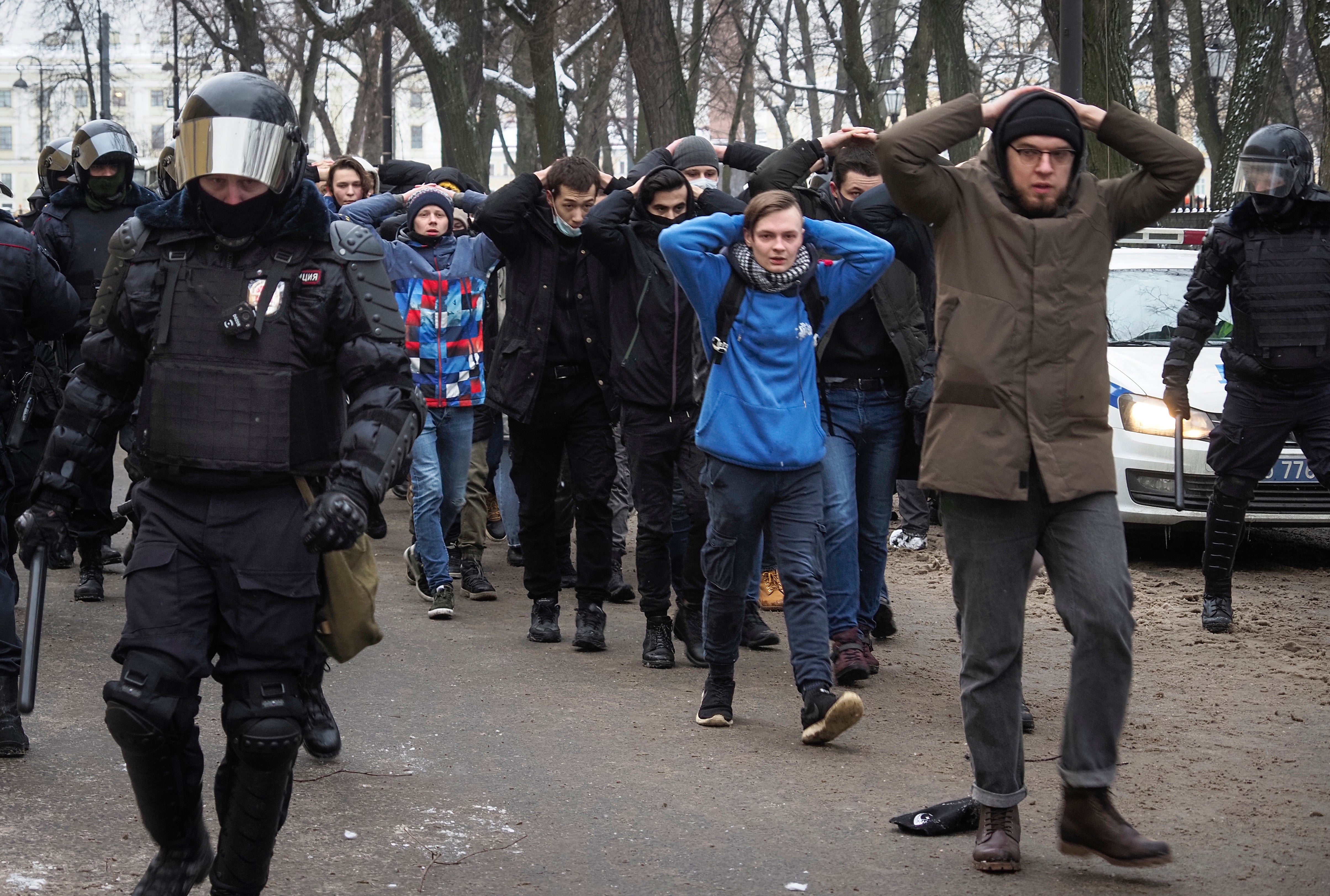 Protesters walk escorted by police during a protest against the jailing of opposition leader Alexei Navalny in St. Petersburg