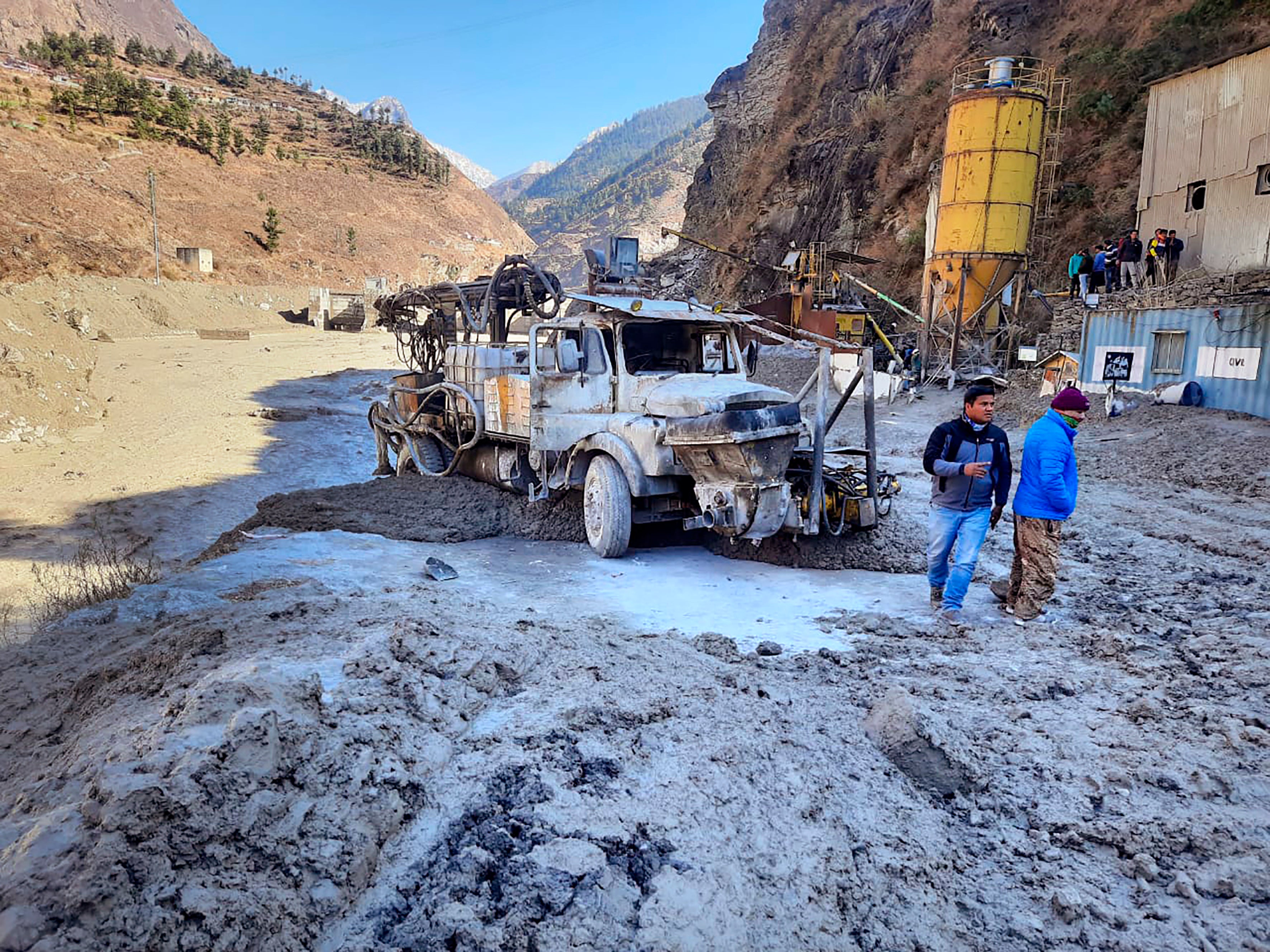 People inspect the site near the damaged Dhauliganga hydropower project at Reni village in Chamoli district after portion of Nanda Devi glacier broke off in Tapovan area of the northern state of Uttarakhand