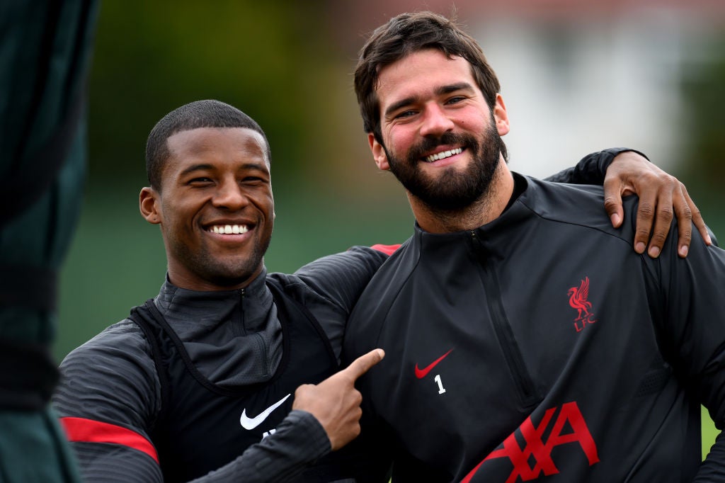 Gini Wijnaldum and Alisson of Liverpool