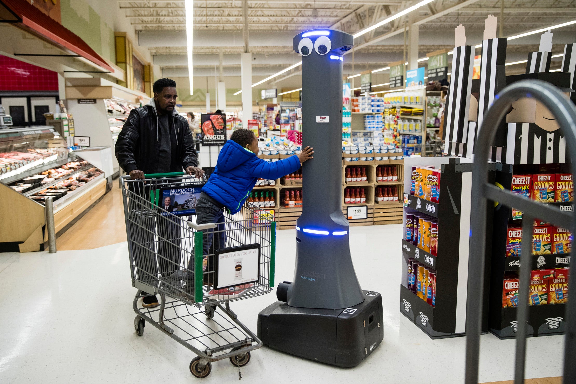 Customers say hello to a robot named Marty as it cleans the floors at a grocery store in Harrisburg, Pennsylvania