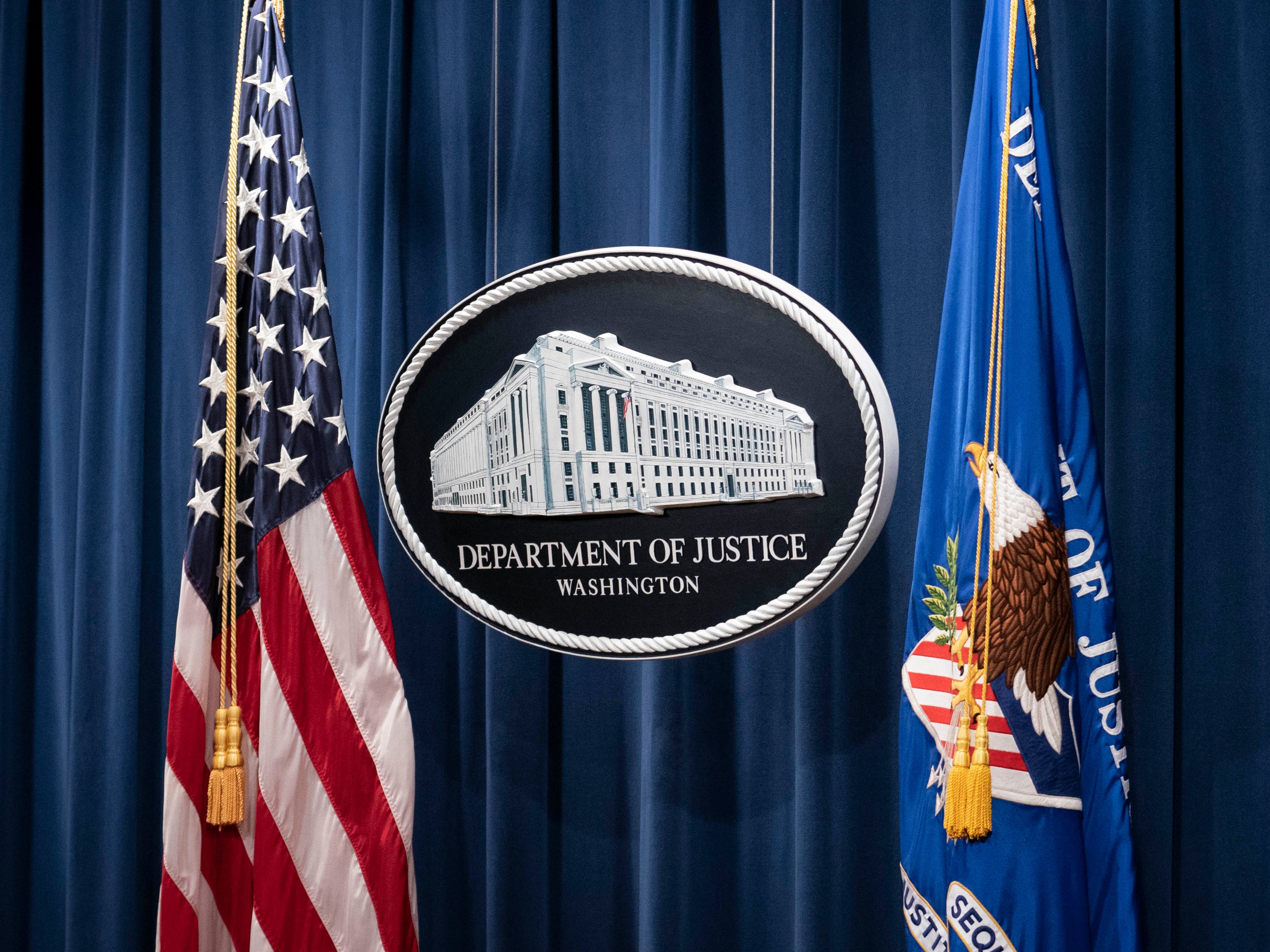 <p>A sign for the Department of Justice is seen ahead of a news conference with Michael Sherwin, acting US attorney for the District of Columbia, and Steven D’Antuono, head of the Federal Bureau of Investigation (FBI) Washington field office, at the US Department of Justice in Washington, DC, on 12 January 2021</p>