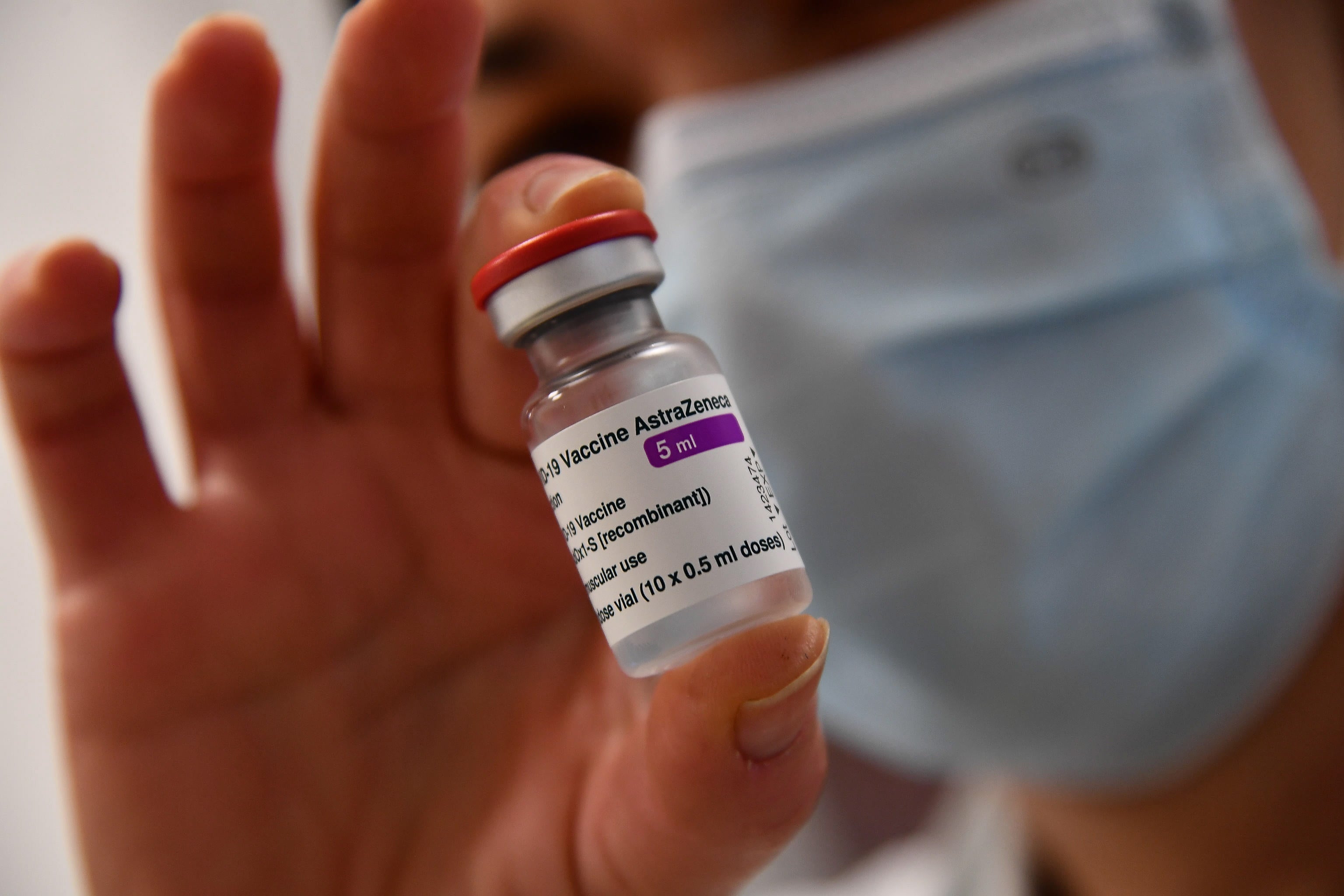 A health worker holds a multiple-dose vial containing the Covid vaccine by British-Swedish multinational pharmaceutical company AstraZeneca, in Genoa, northern Italy