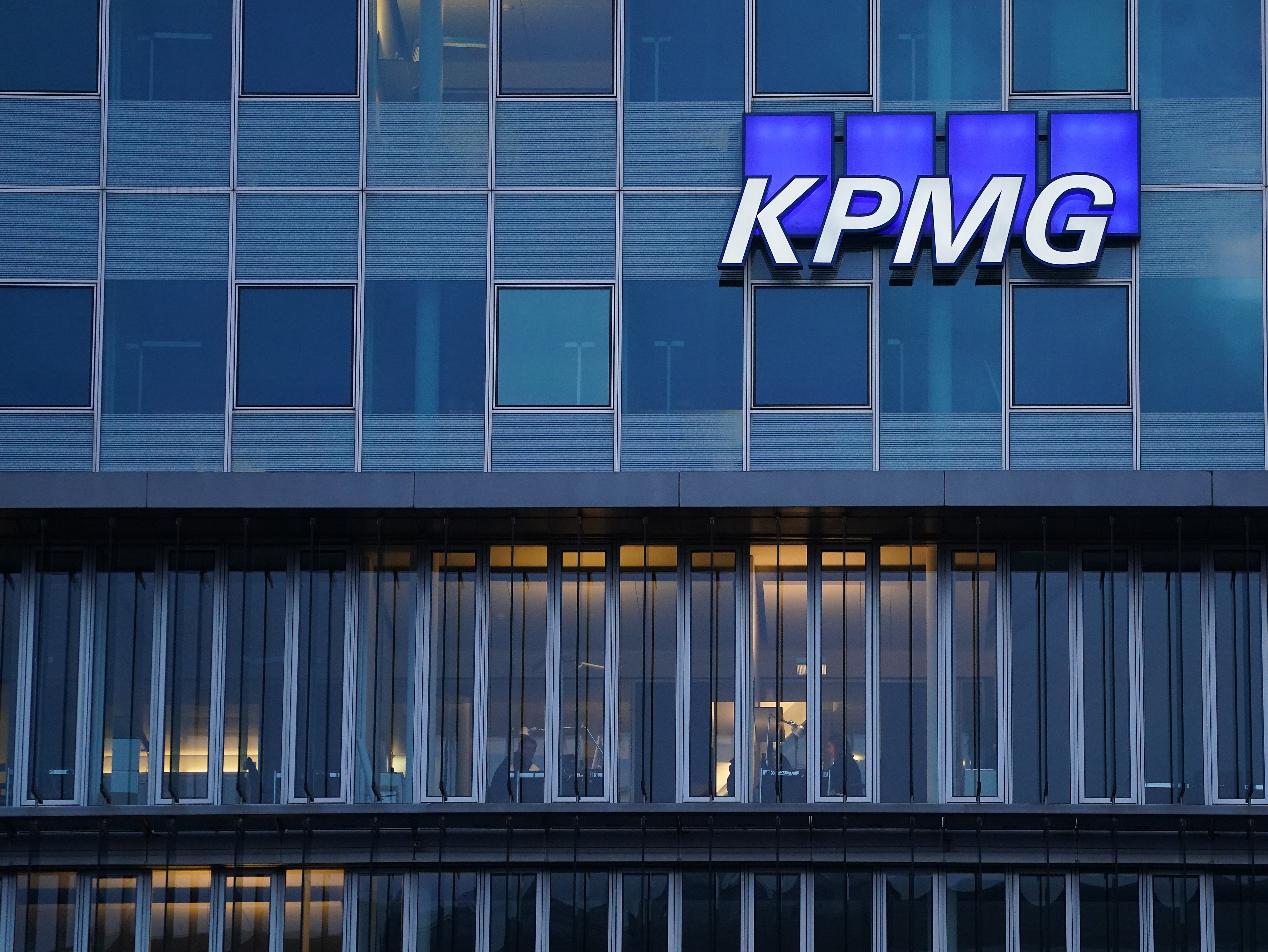 The logo of KPMG, a multinational tax advisory and accounting services company, hangs on the facade of a KPMG offices building on January 22, 2021 in Berlin, Germany