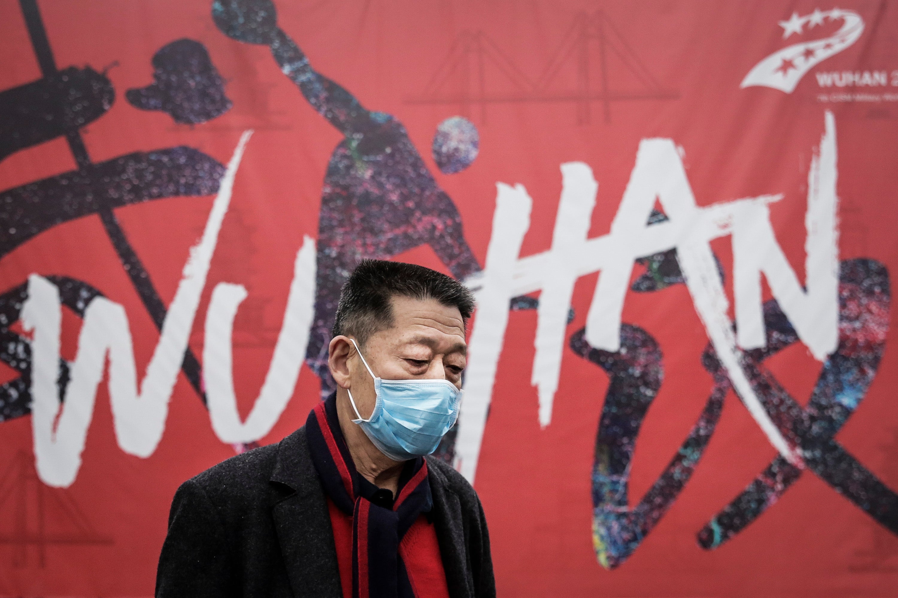 Man wears a mask while walking in the street in Wuhan, China