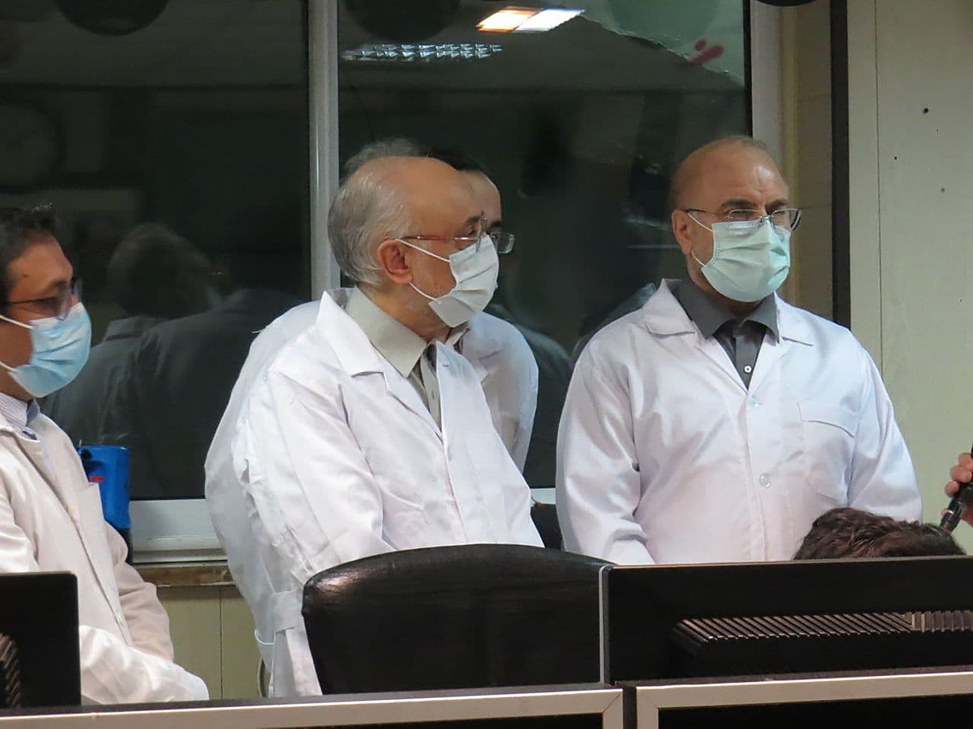 A handout picture provided by Iran’s Atomic Energy Organisation on January 30, 2021 shows Iranian Parliament speaker Mohammad Bagher Ghalibaf (R) and the head of the Iranian Atomic Organization Ali Akbar Salehi (L) visiting the Fordo nuclear power plant, central Iran, on January 28.