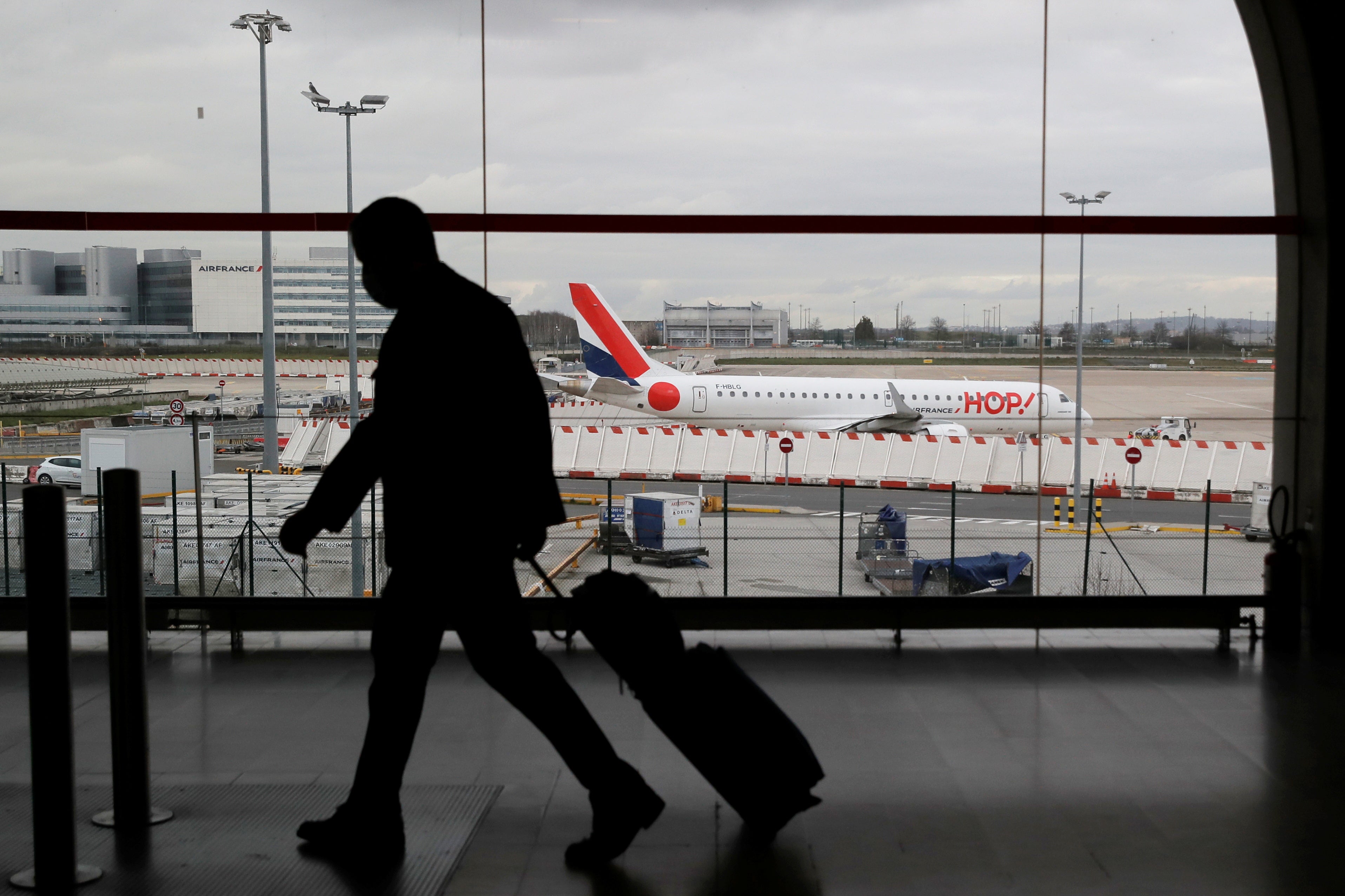 A man walks inside a terminal at Paris Charles de Gaulle Airport