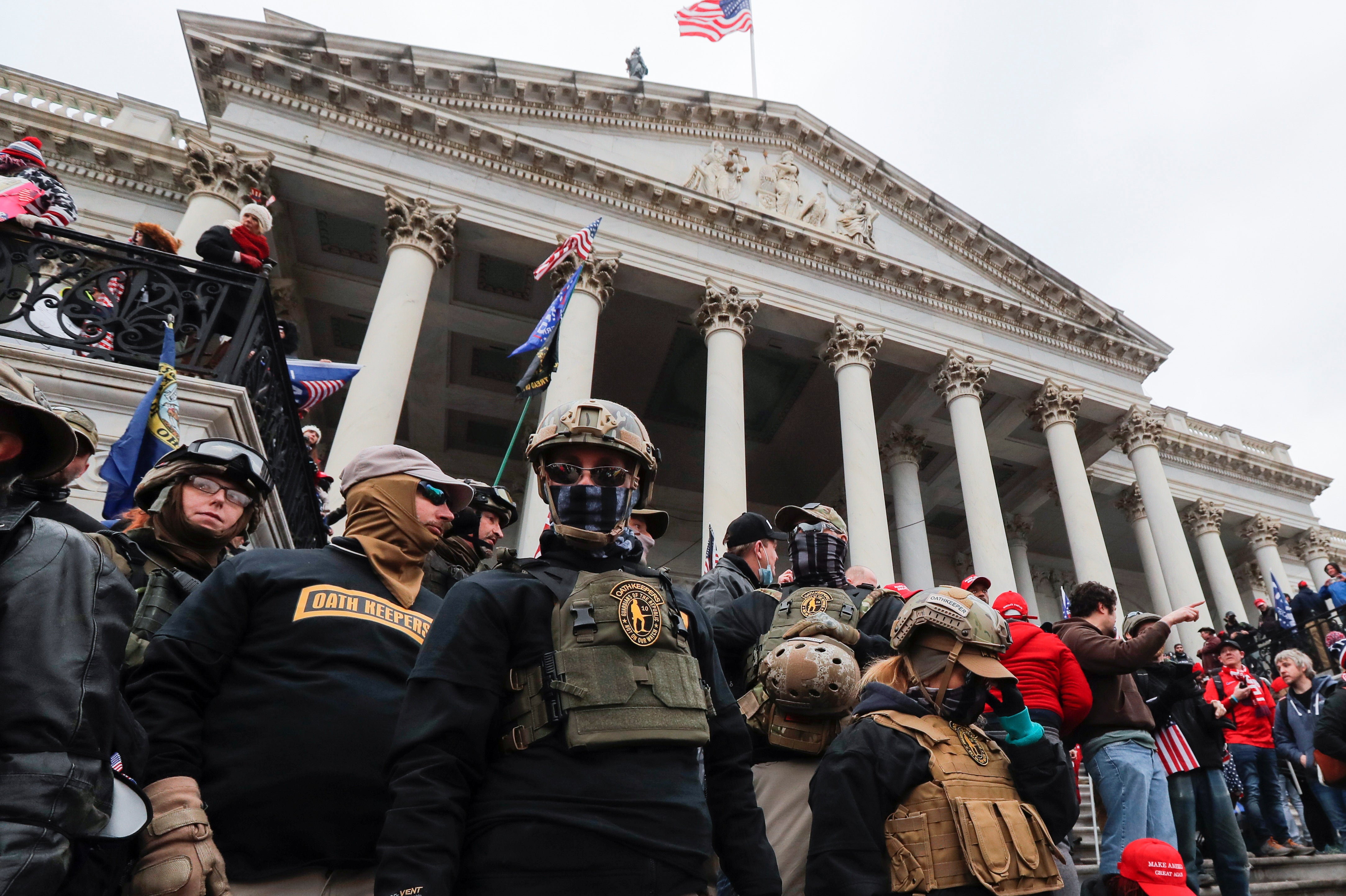 Members of the Oath Keepers militia group occupying the east front steps of the US Capitol in Washington on 6 January 2021