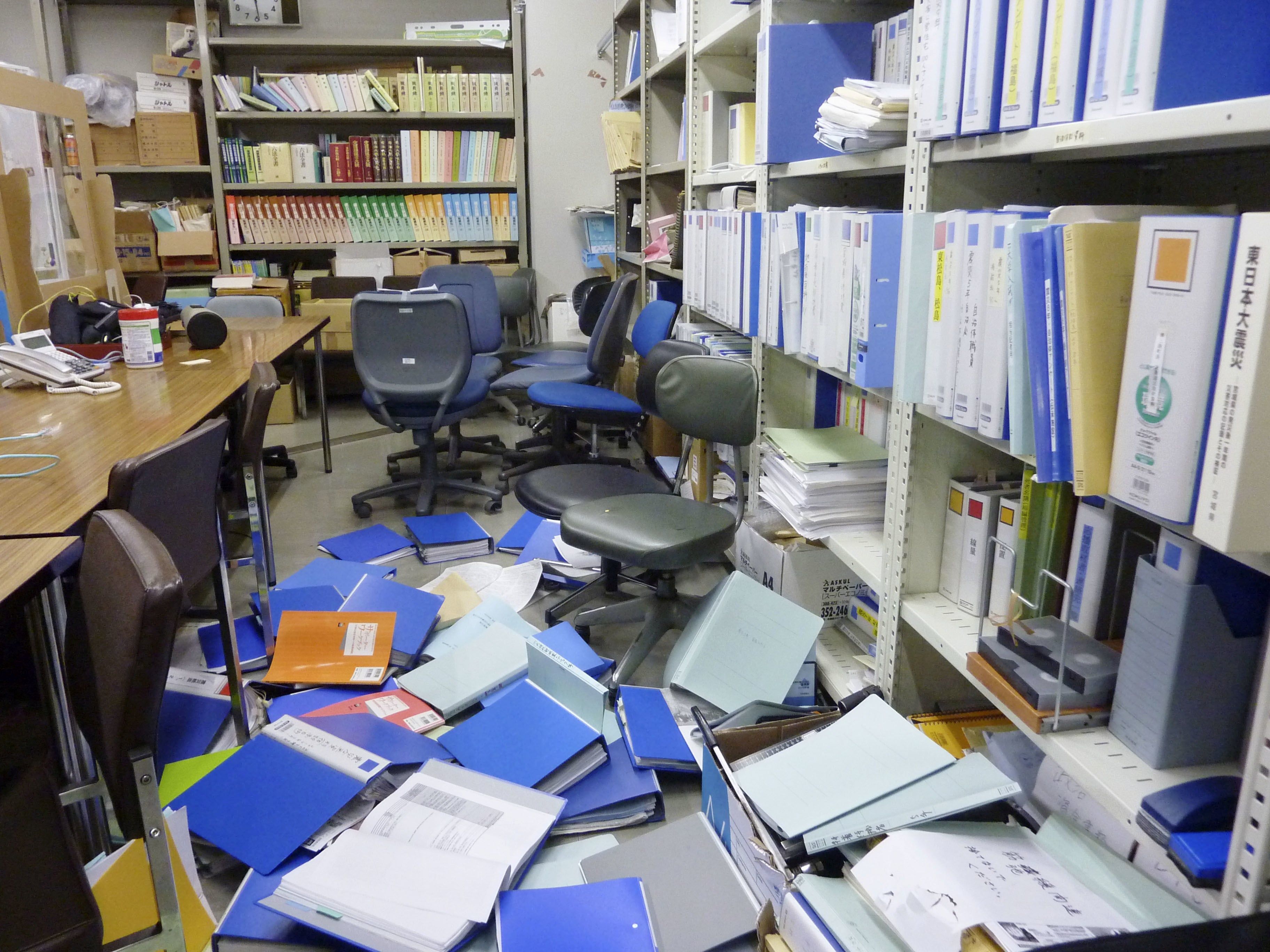 File folders are seen scattered on the floor of the Kyodo News bureau after a strong quake in Sendai, Miyagi Prefecture