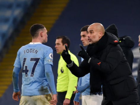 Guardiola talks to Foden during the Premier League match between Man City and Tottenham