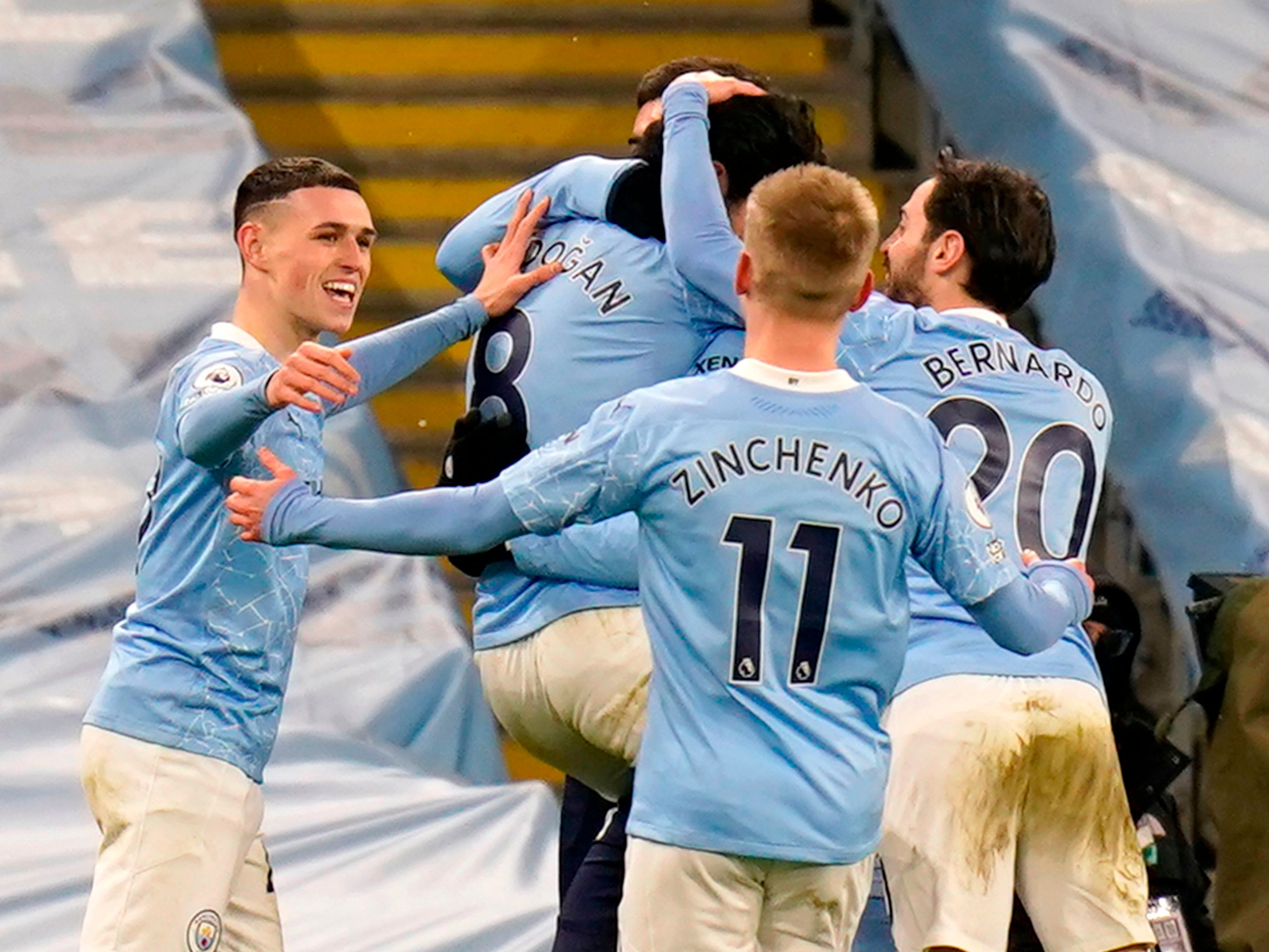 Ilkay Gundogan is mobbed after scoring City’s second goal against Tottenham