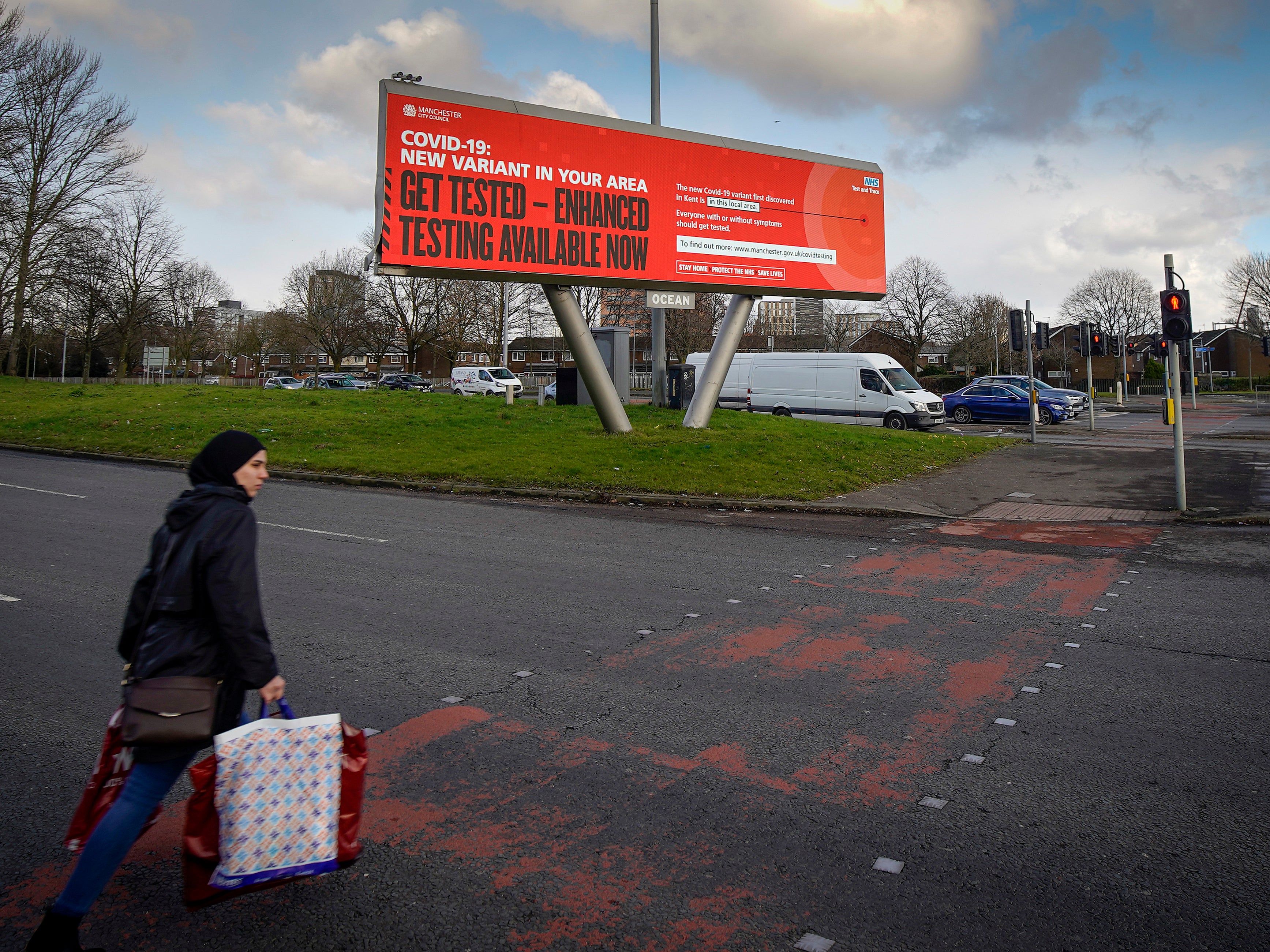 An electronic sign at Hulme warns members of the public to protect themselves against a new coronavirus variant