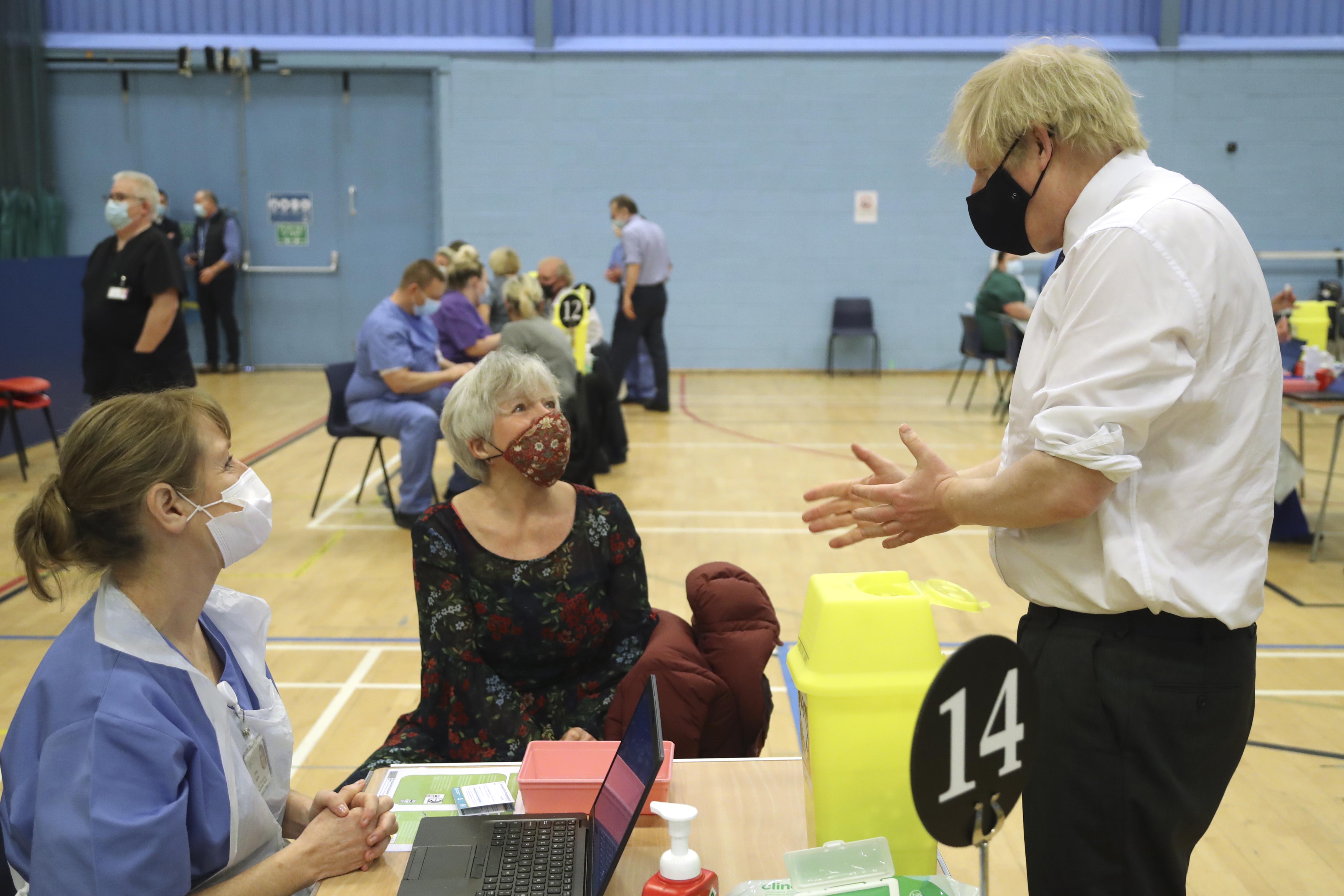 Boris Johnson speaking to members of the public as they wait to receive an Oxford-AstraZeneca vaccine in south Wales