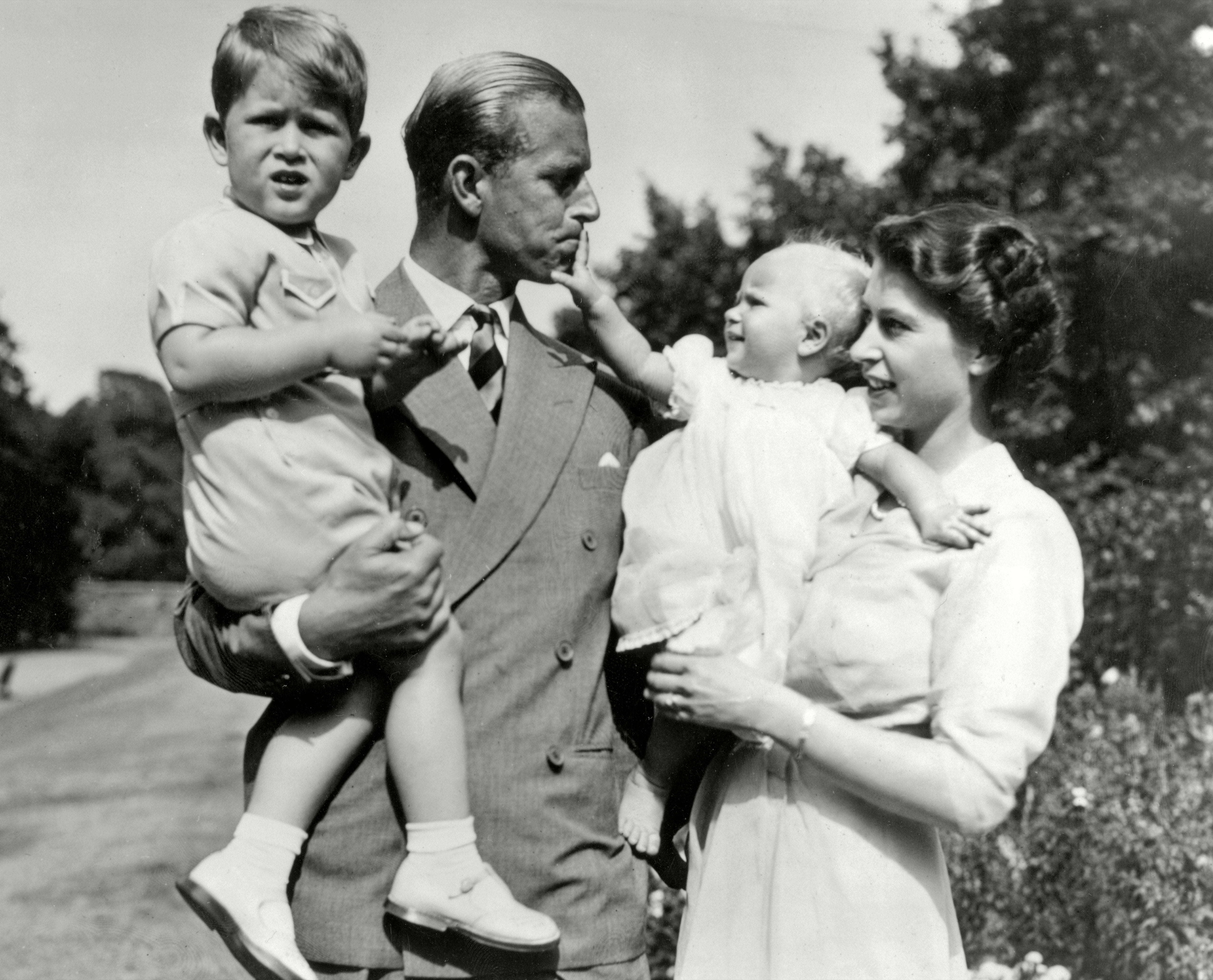 Queen Elizabeth II and the Duke of Edinburgh holding Prince Charles and Princess Anne, 1952