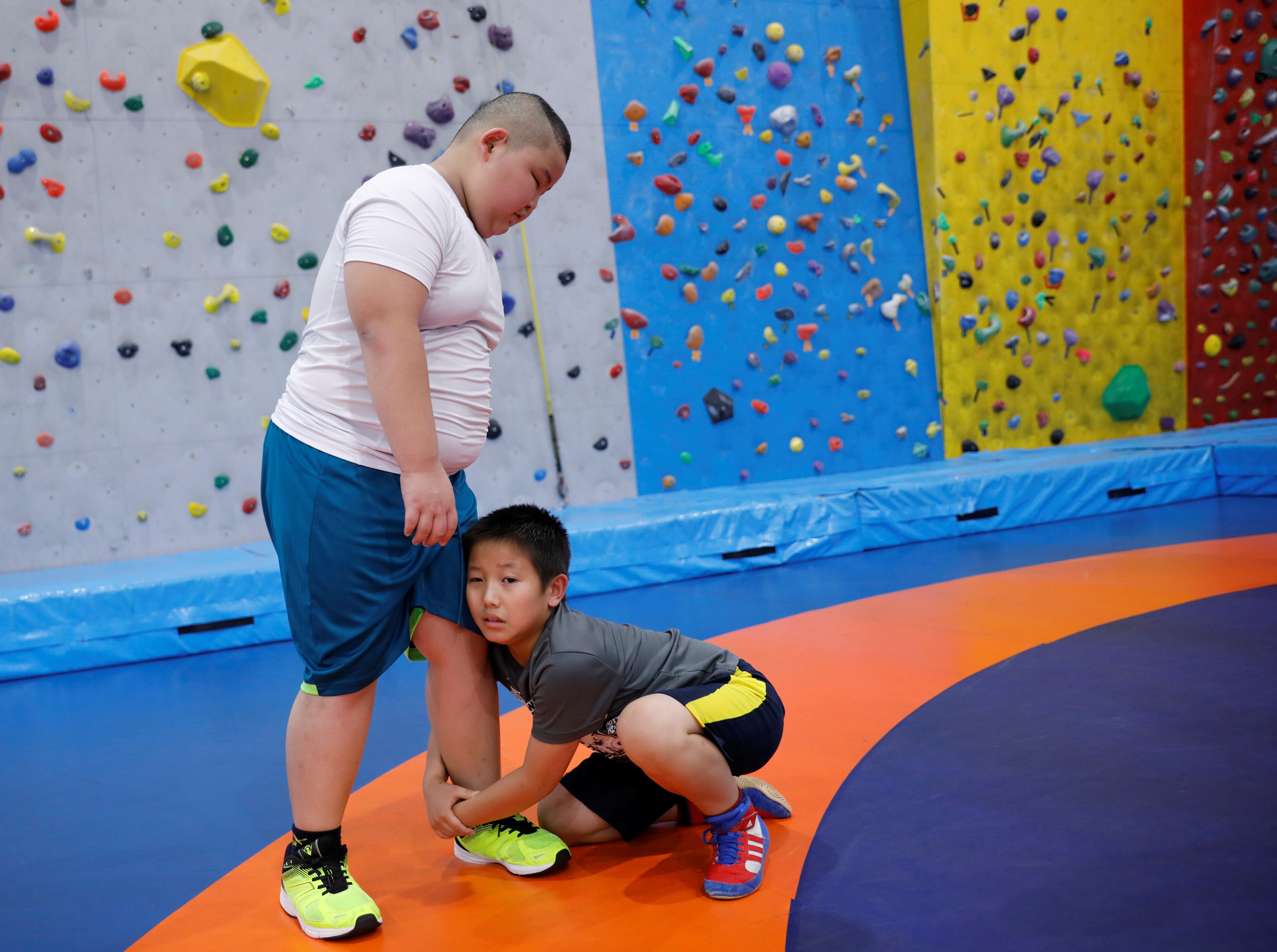 Kyuta wrestles with a boy the same age as him, during a training session