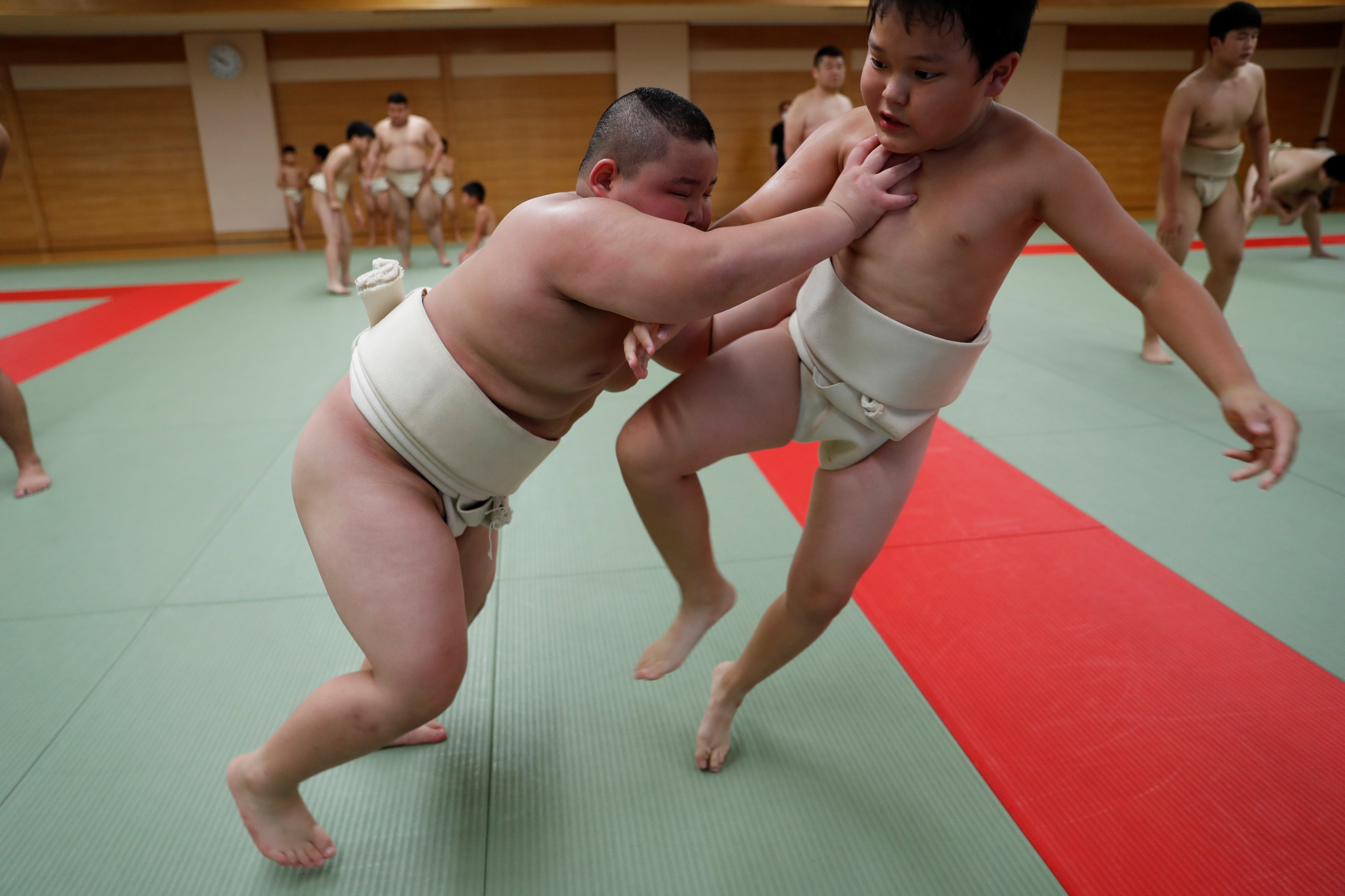 Kyuta practises sumo with a boy at Komatsuryu sumo club in Tokyo