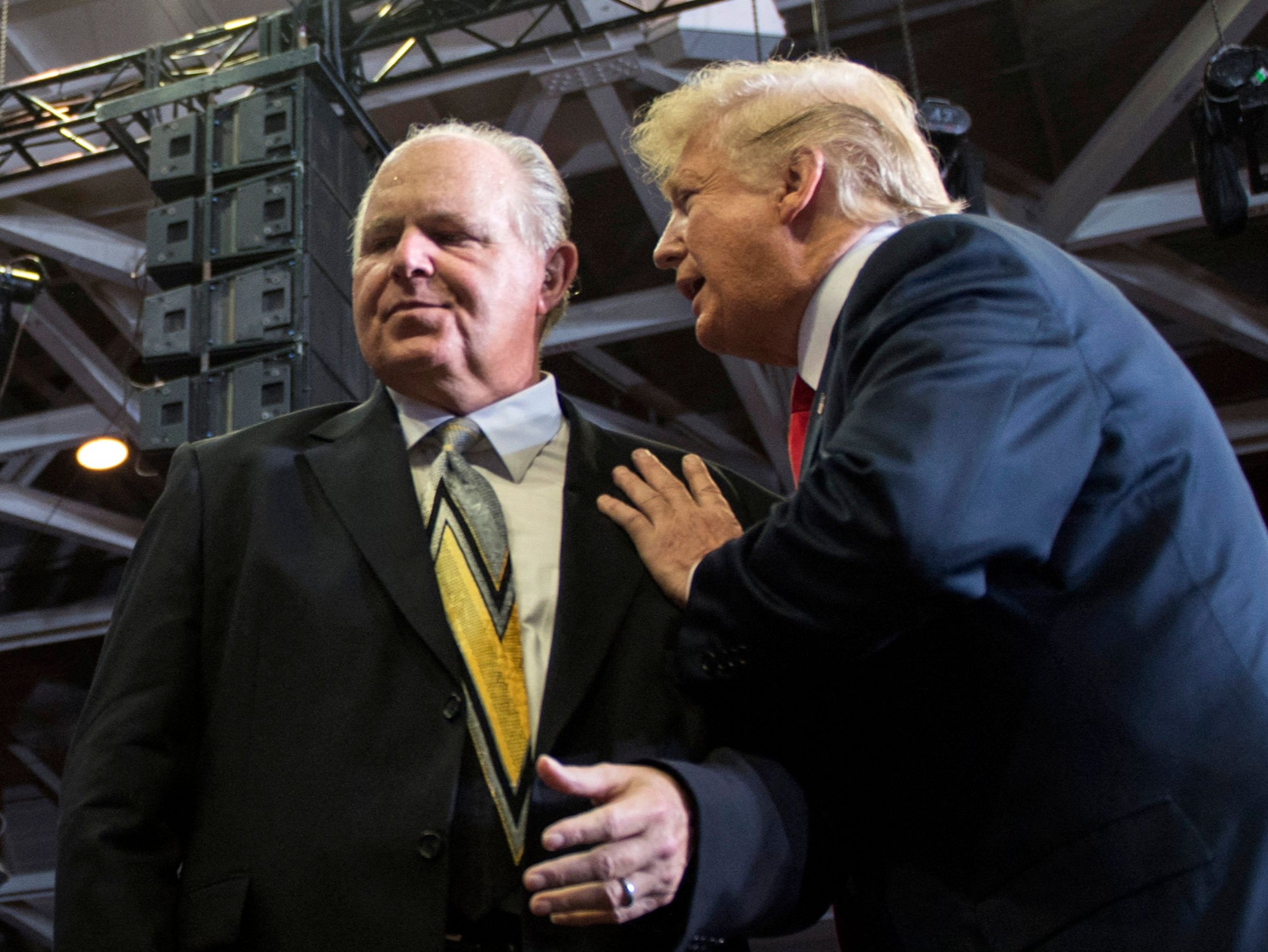 Donald Trump speaks to radio talk show host Rush Limbaugh at a Make America Great Again rally in Cape Girardeau, Missouri.