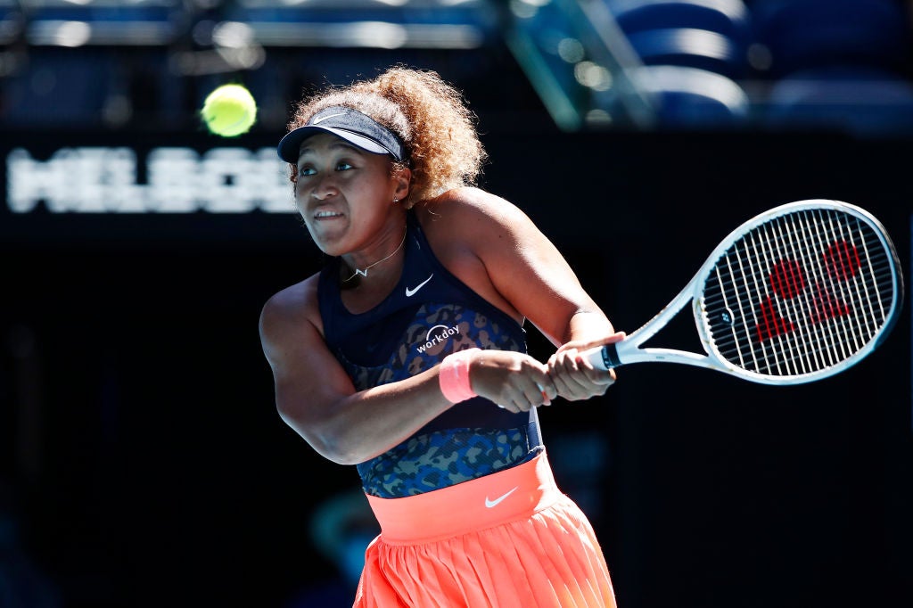 Naomi Osaka plays a backhand against Serena Williams