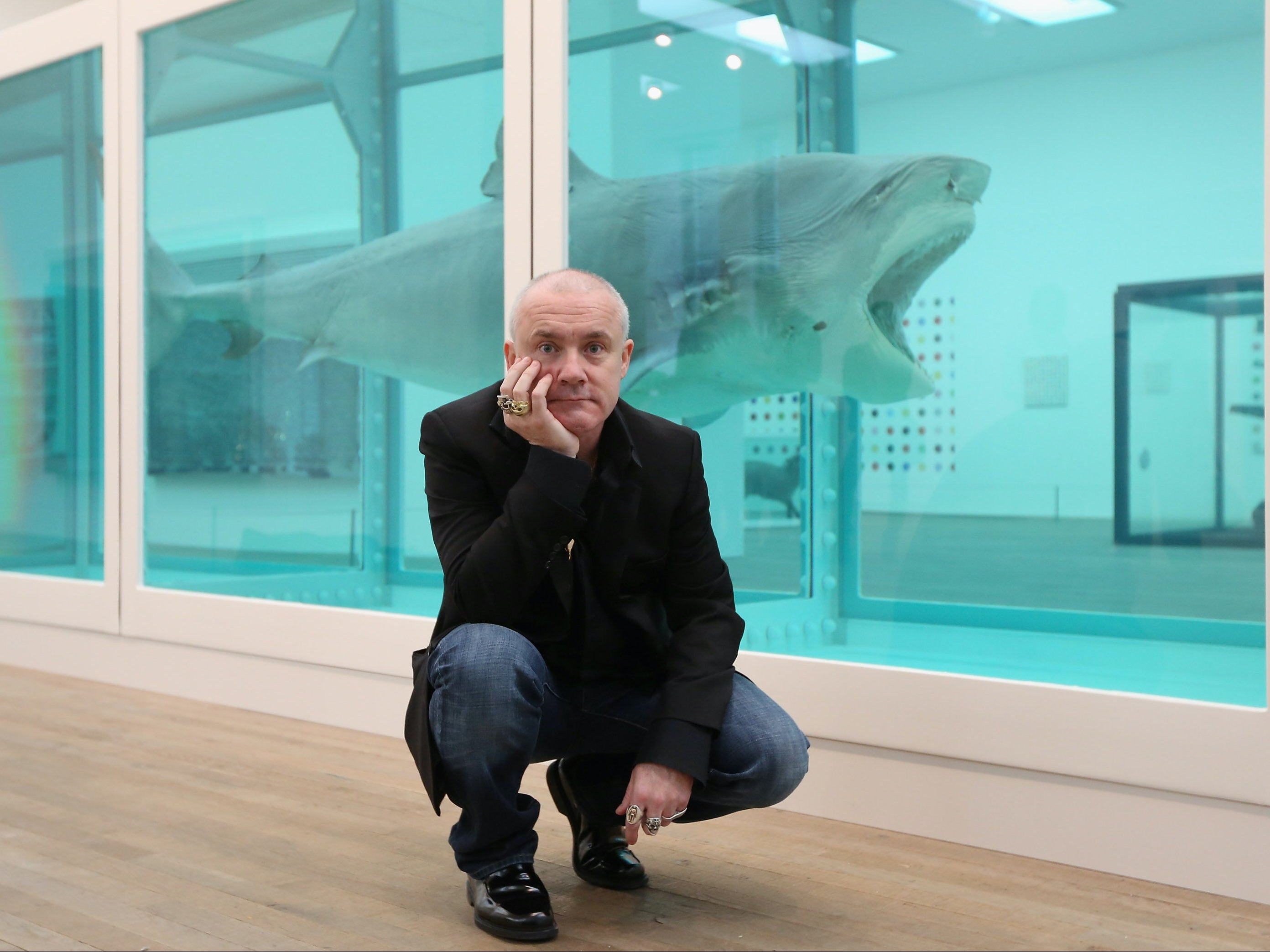 Hirst with his artwork, titled The Physical Impossibility of Death in the Mind of Someone Living