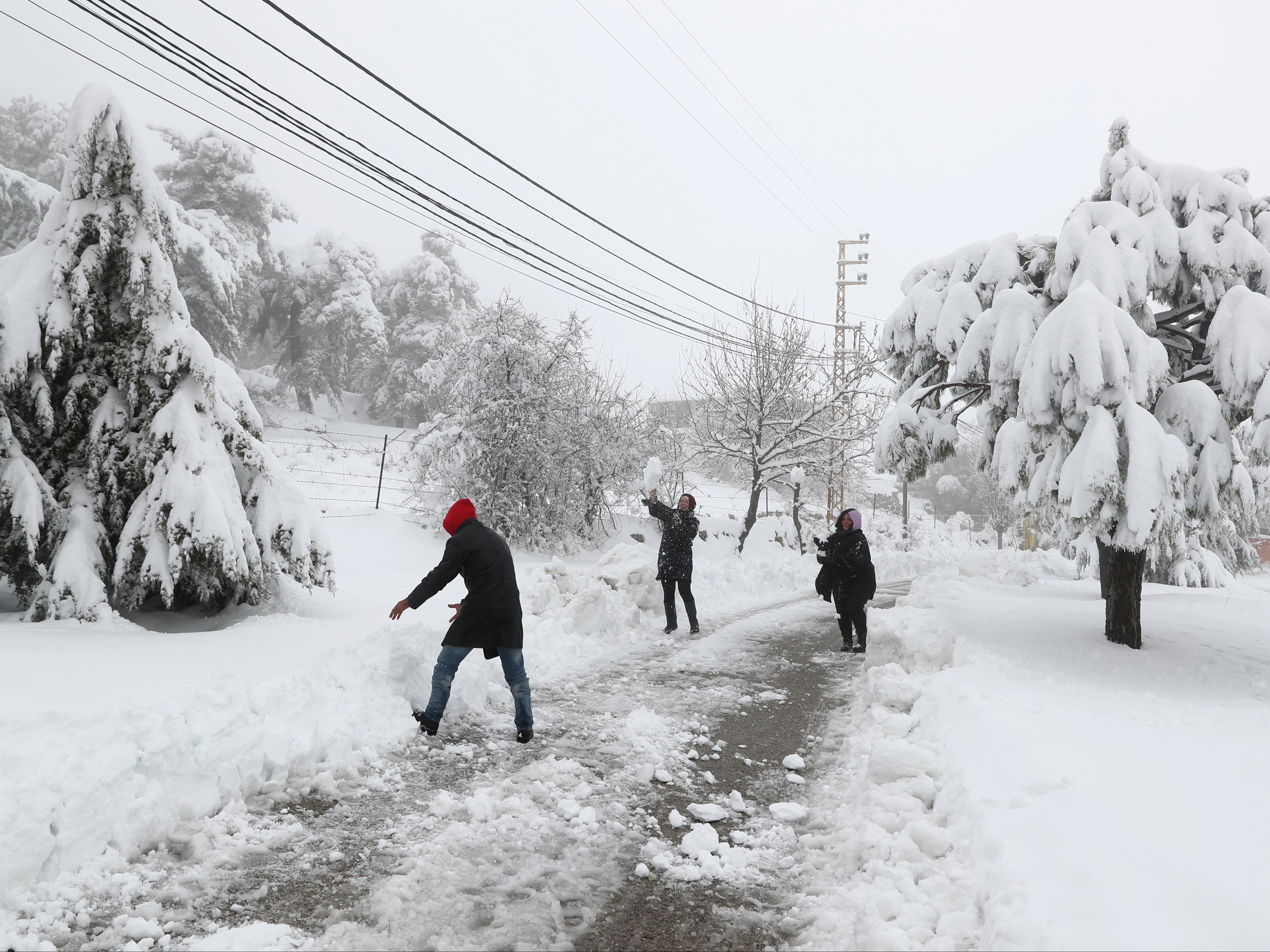 A Syrian family have a snowball fight during a heavy snowfall in Sawfar village, Mount Lebanon Governorate of Lebanon