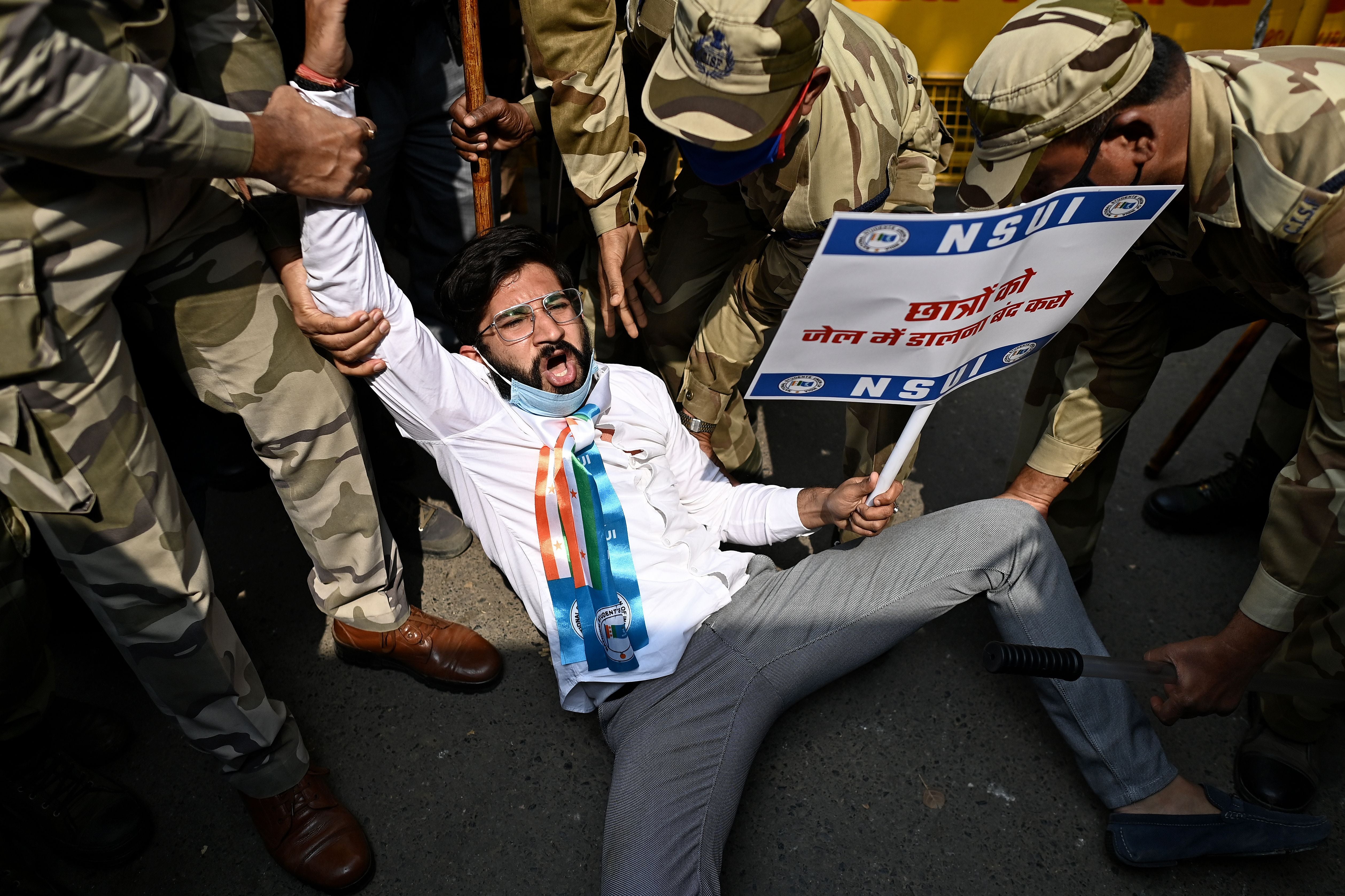 Police detain an activist during a protest against the arrest of Disha Ravi in New Delhi, on 17 February 2021