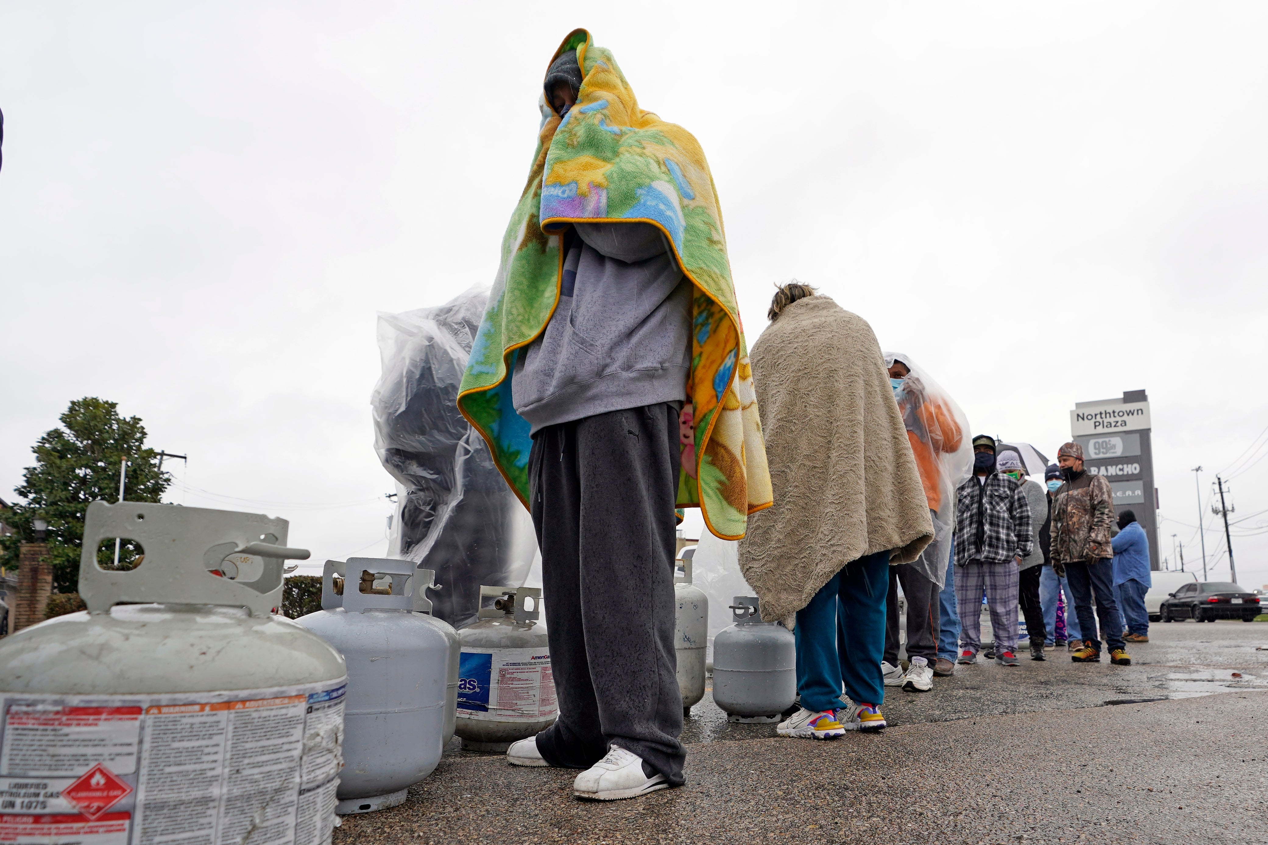 Customers queue up for over an hour in the freezing rain to fill their tanks n 17 February.