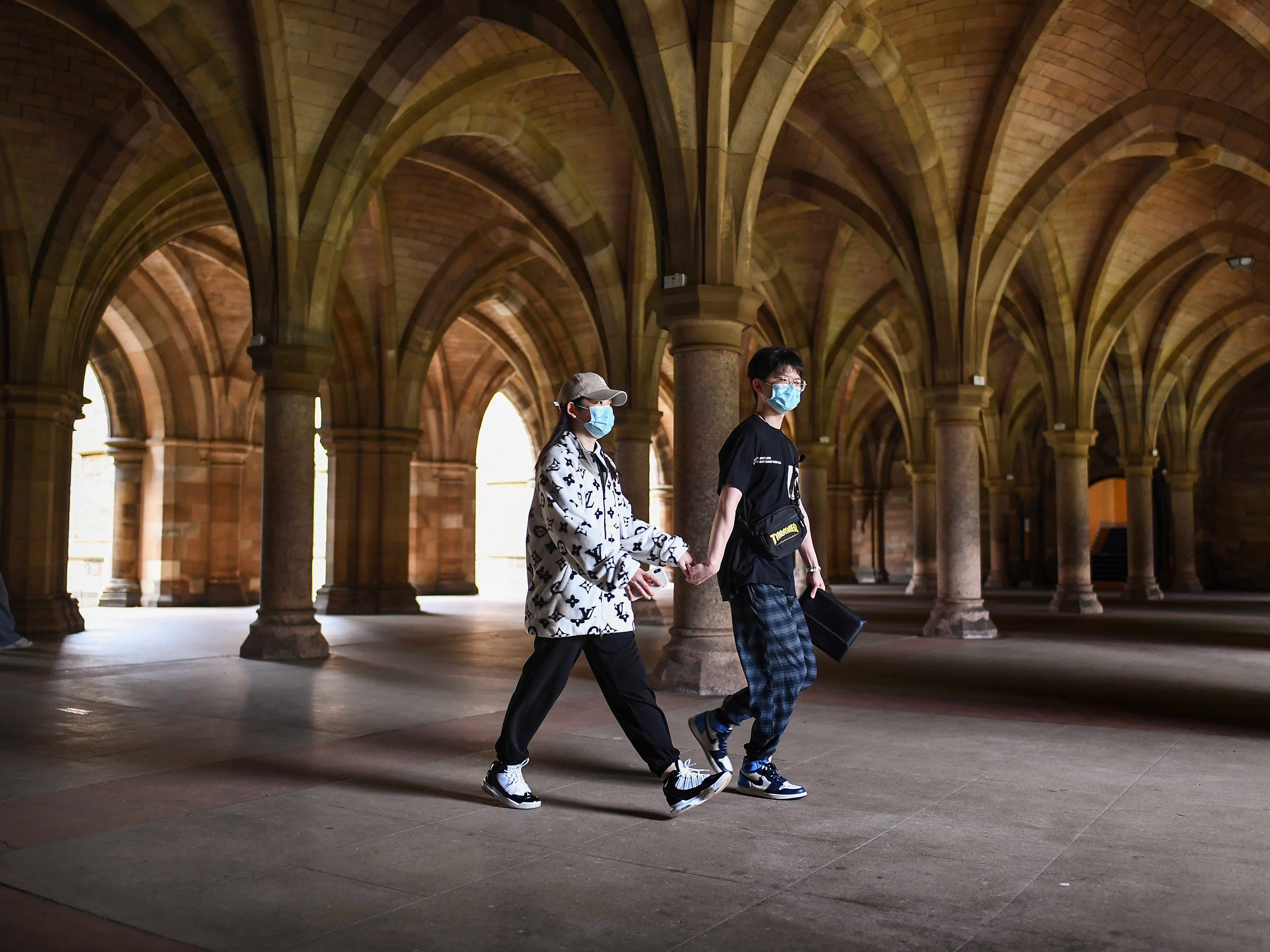 Some students walk through the cloisters at Glasgow University amid an outbreak of Covid there in September 2020