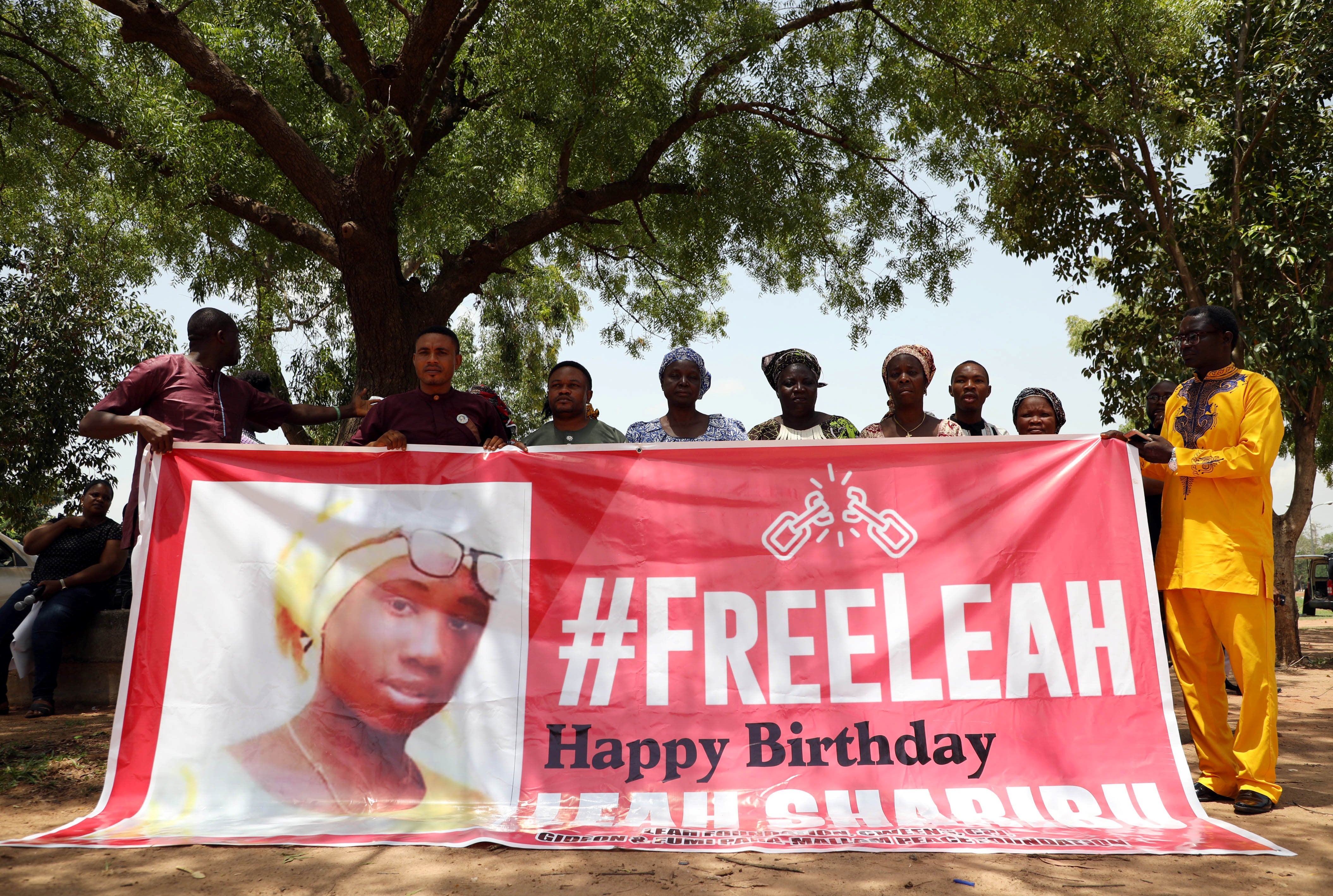 Leah Sharibu’s family members hold banner to demand she is released at event to mark her 16th birthday in Abuja in Nigeria in 2019