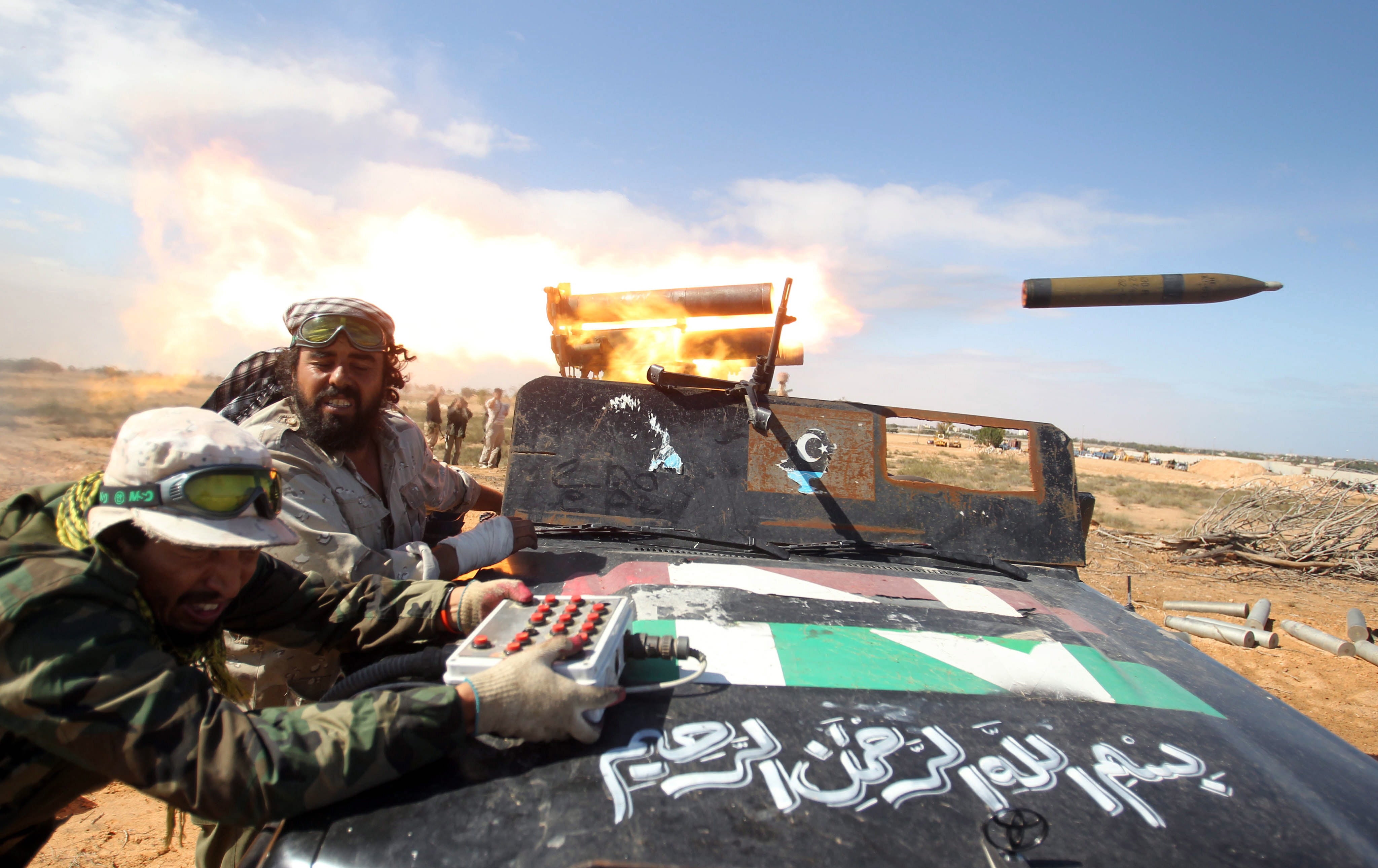 Libyan rebels fire a rocket as they enter in Sirte, Libya, 10 October 2011