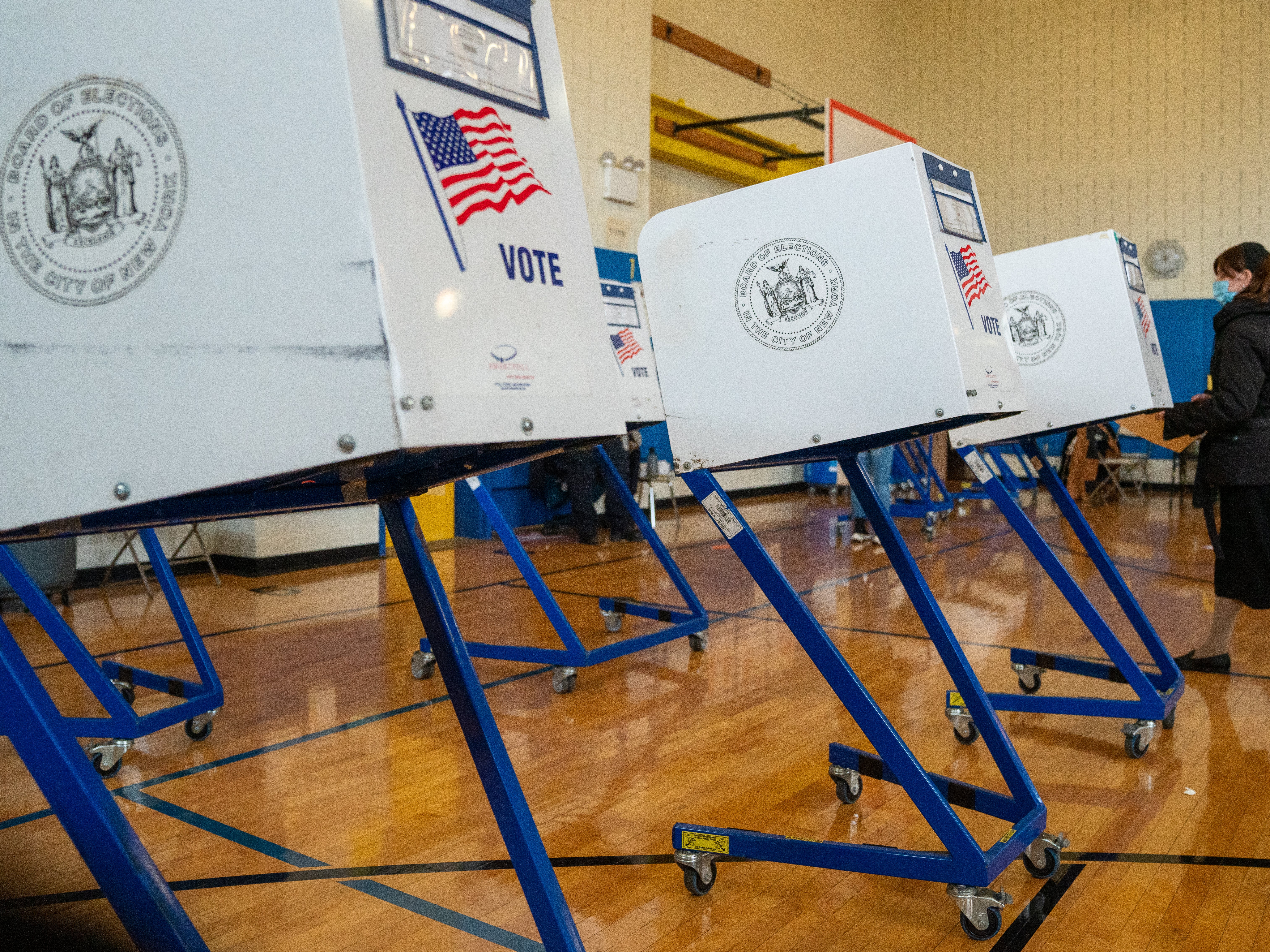 A voter walks to a booth to fill out their ballot at Public School 160 on 3 November 2020 in the Brooklyn borough of New York City