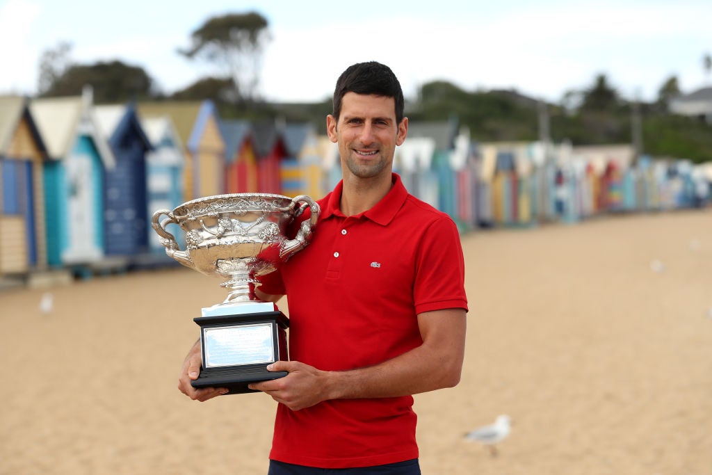 Novak Djokovic poses with the Norman Brookes Challenge Cup