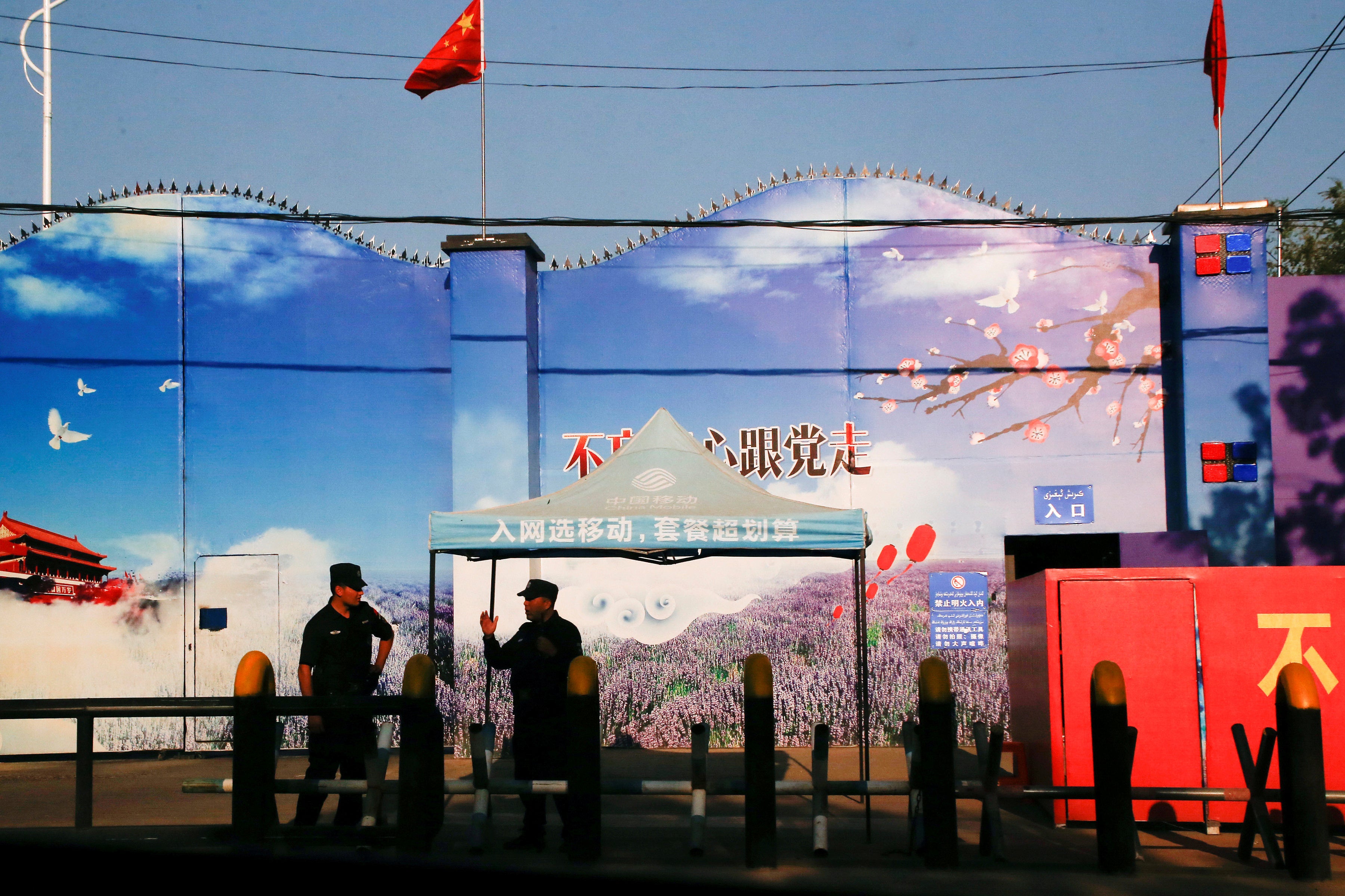 File: Security guards stand at the gates of what is officially known as a ‘vocational skills education centre’ in Huocheng County in Xinjiang, China