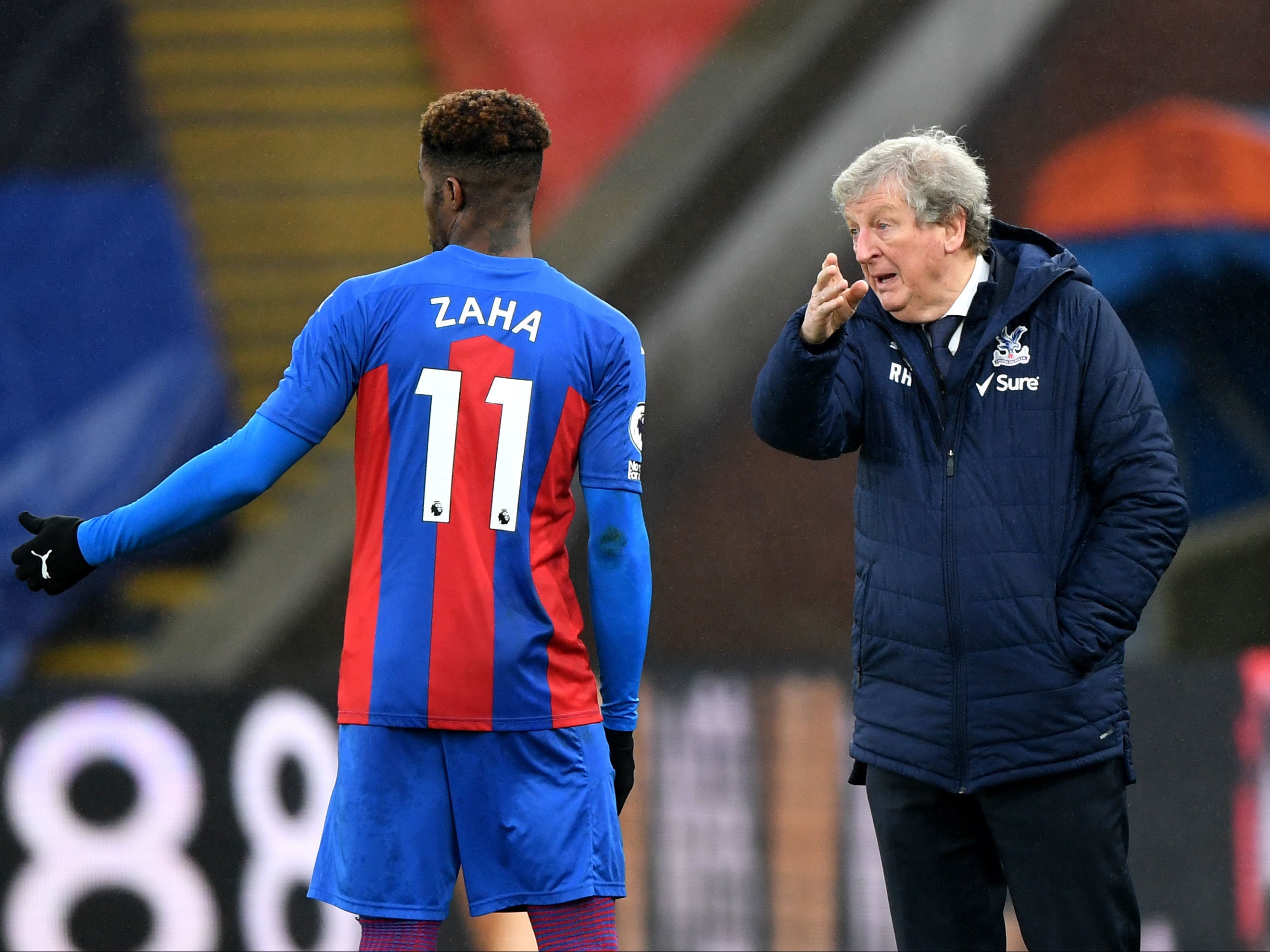 Crystal Palace manager Roy Hodgson and Wilfried Zaha