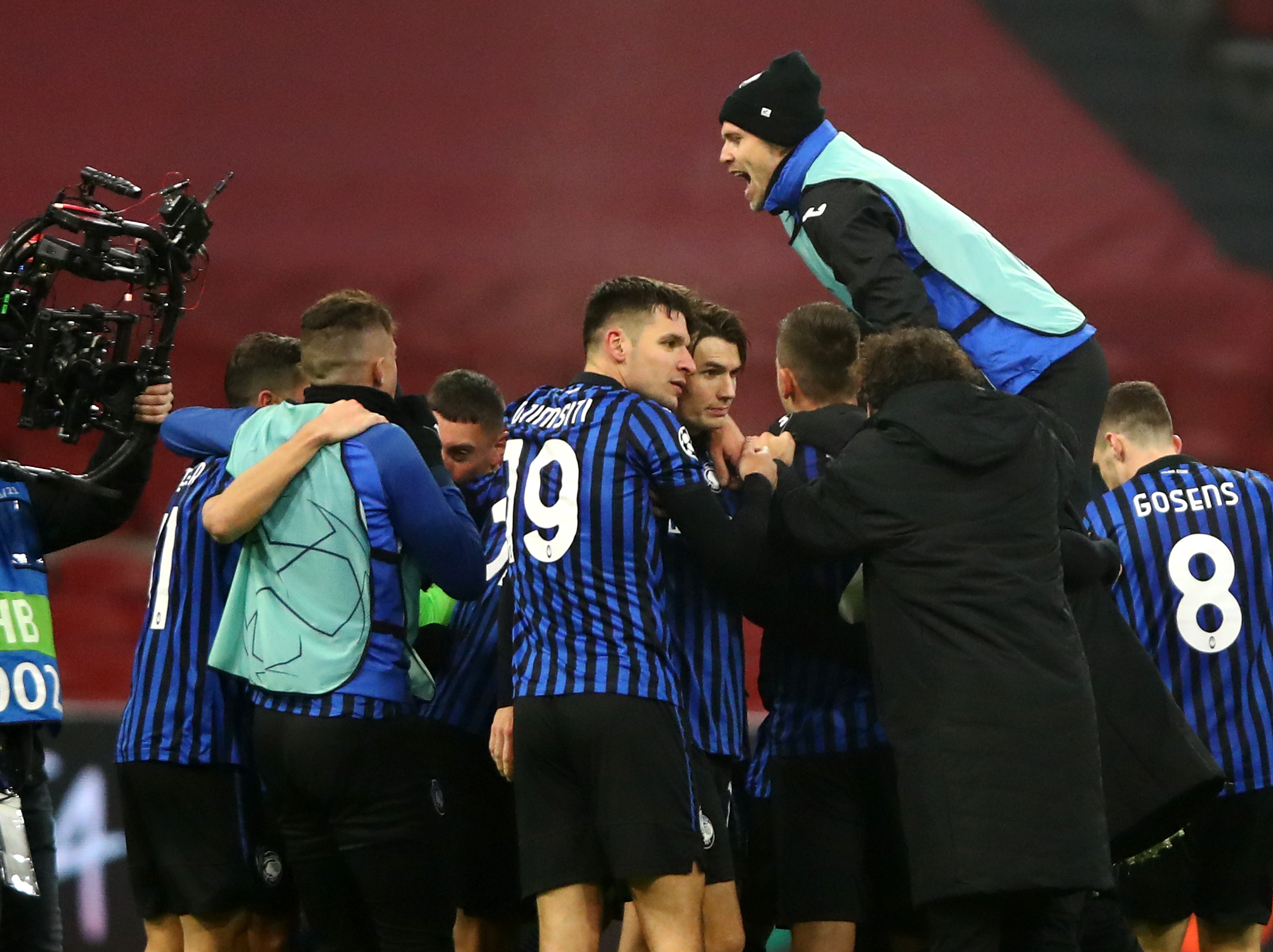 Atalanta players celebrate beating Ajax in the group stage