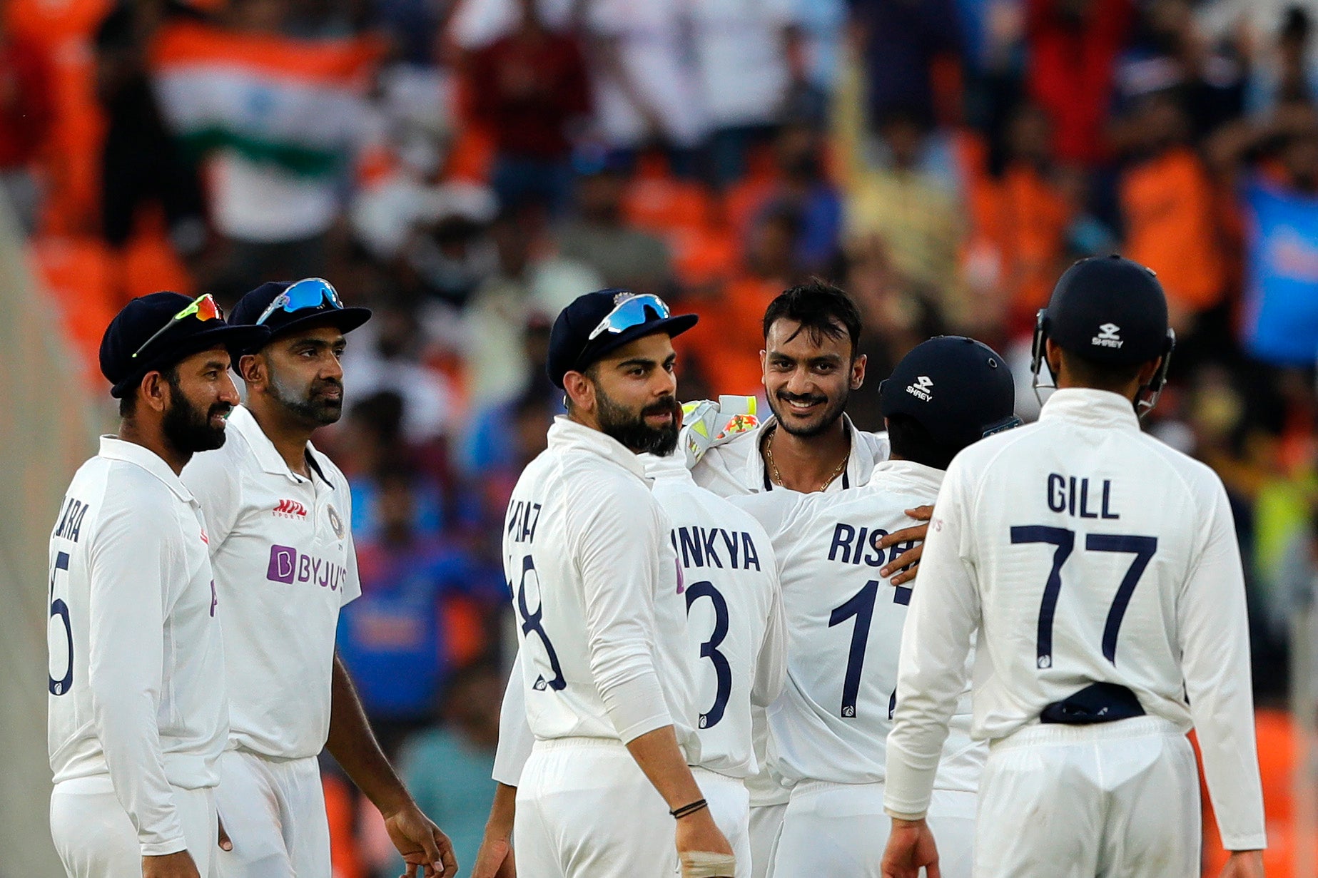 India celebrate after Axar takes a wicket on day one