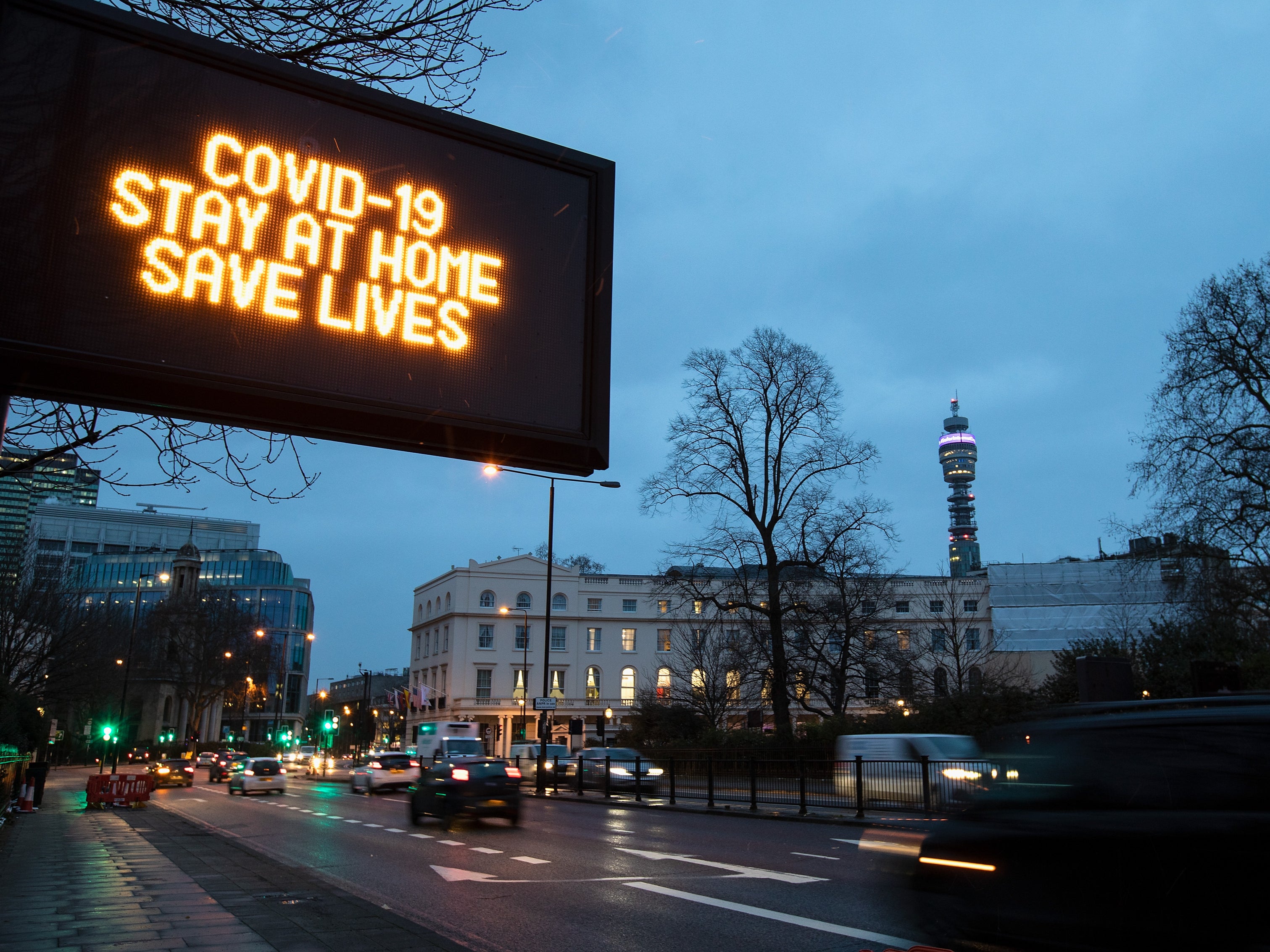 COVID-19 An illuminated road sign, which reads "COVID-19 STAY AT HOME SAVE LIVES" on Marylebone Road