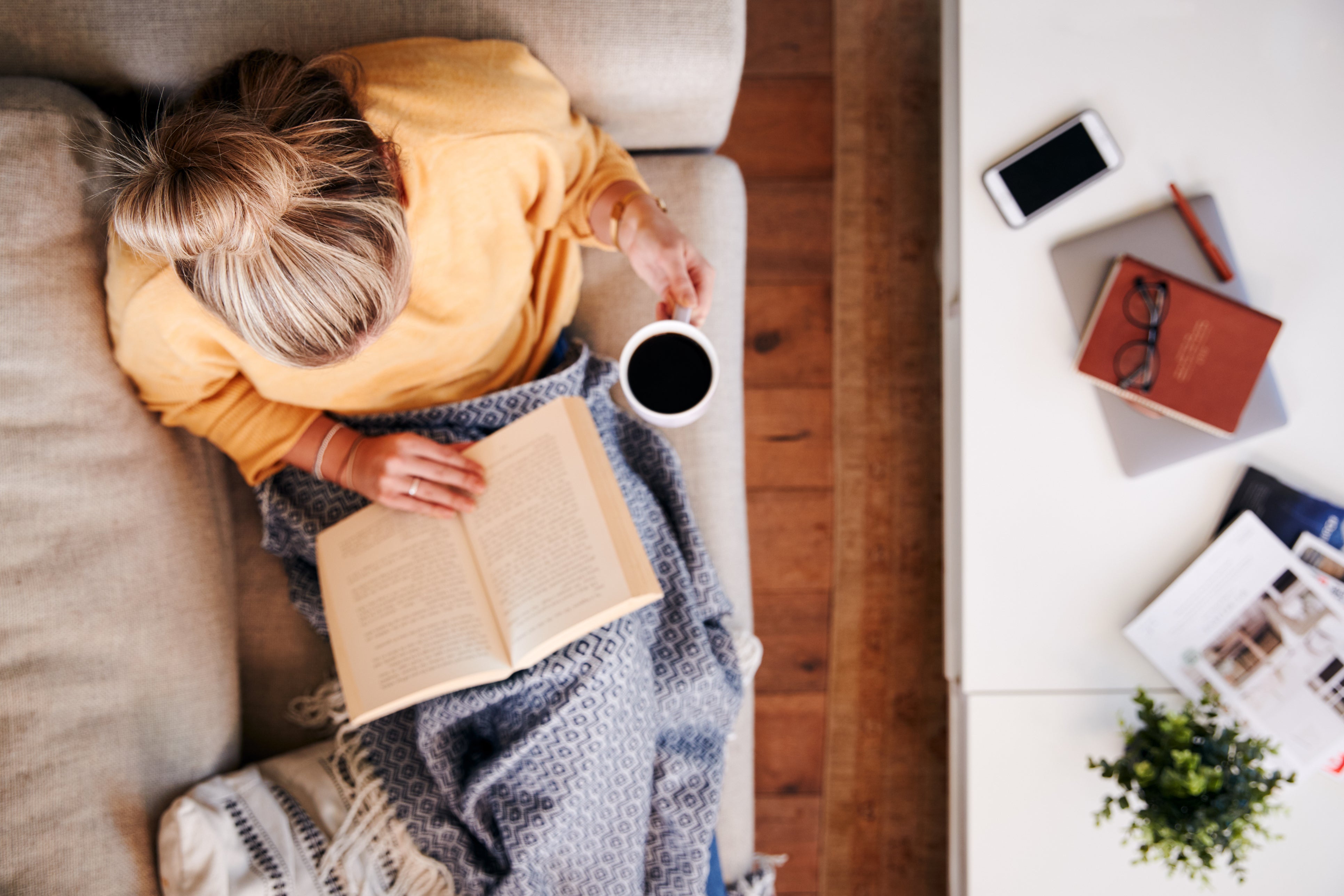 woman having a coffee and reading a book