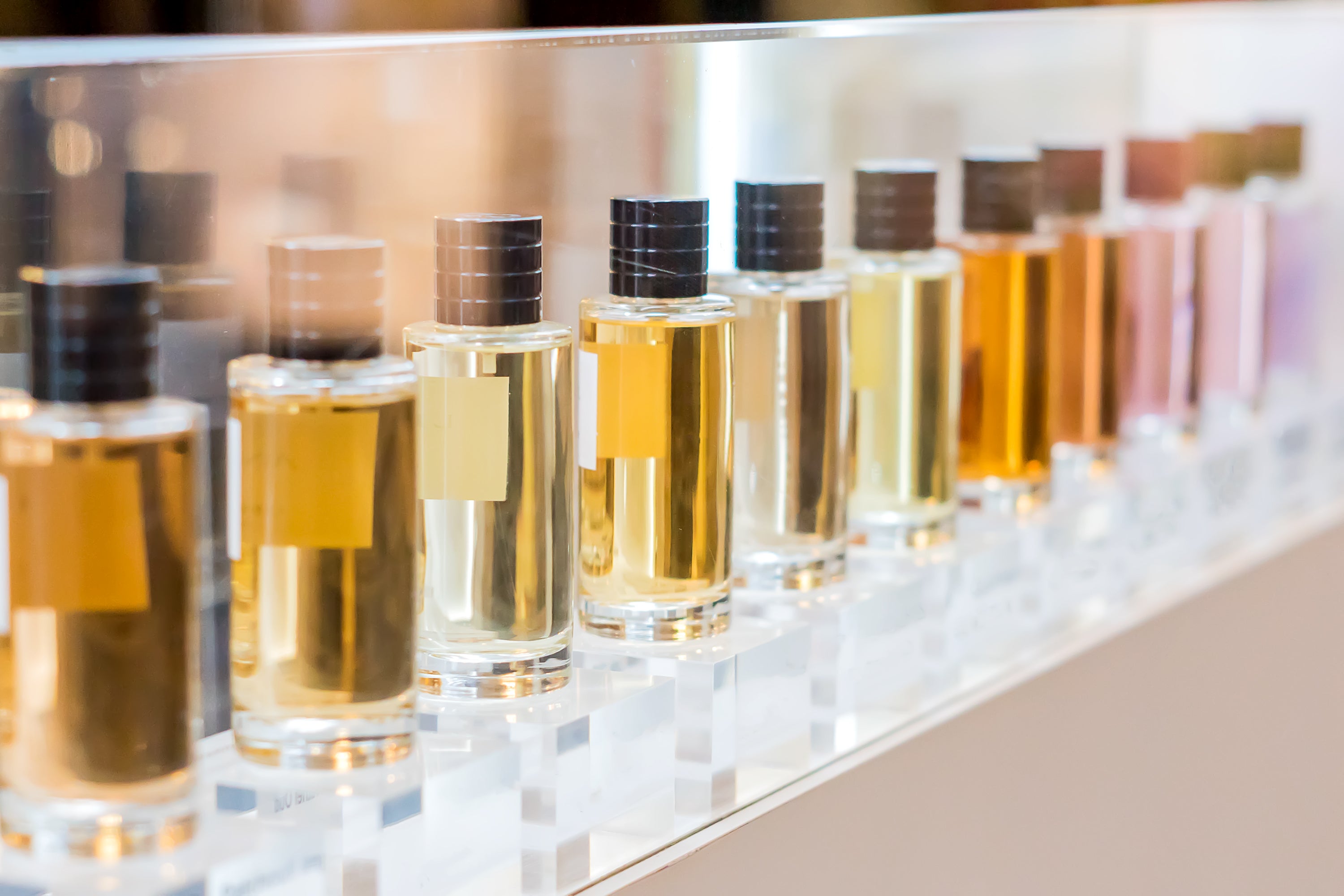 set of colorful perfume bottles in shop window