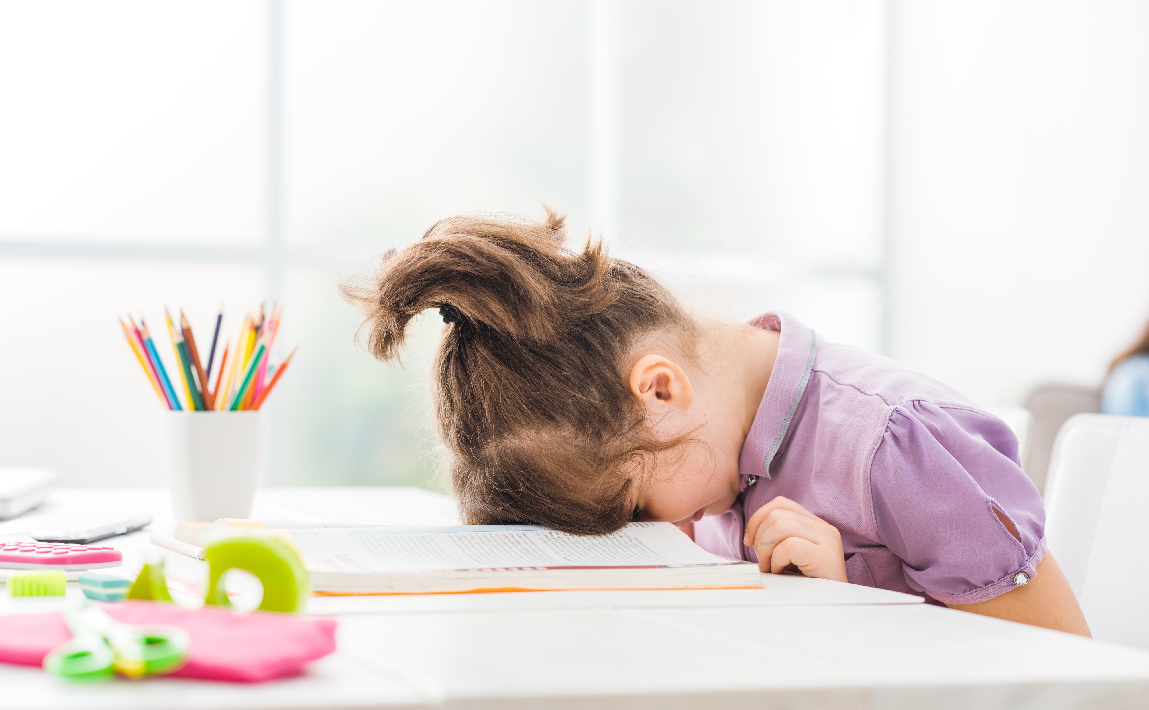 bored girl with her head on the table