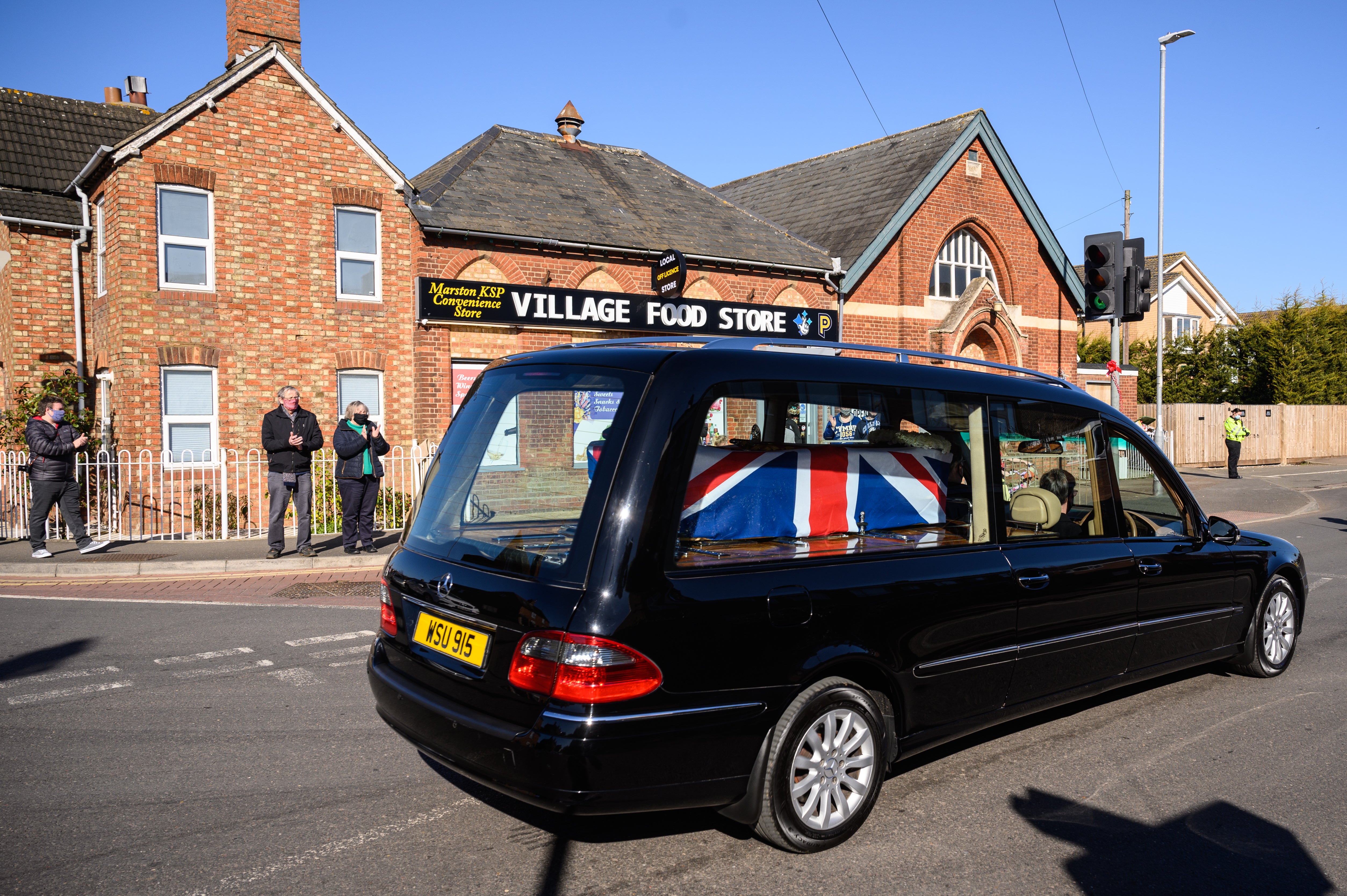 The funeral procession for Sir Tom Moore passes through the village of Marston Moretaine