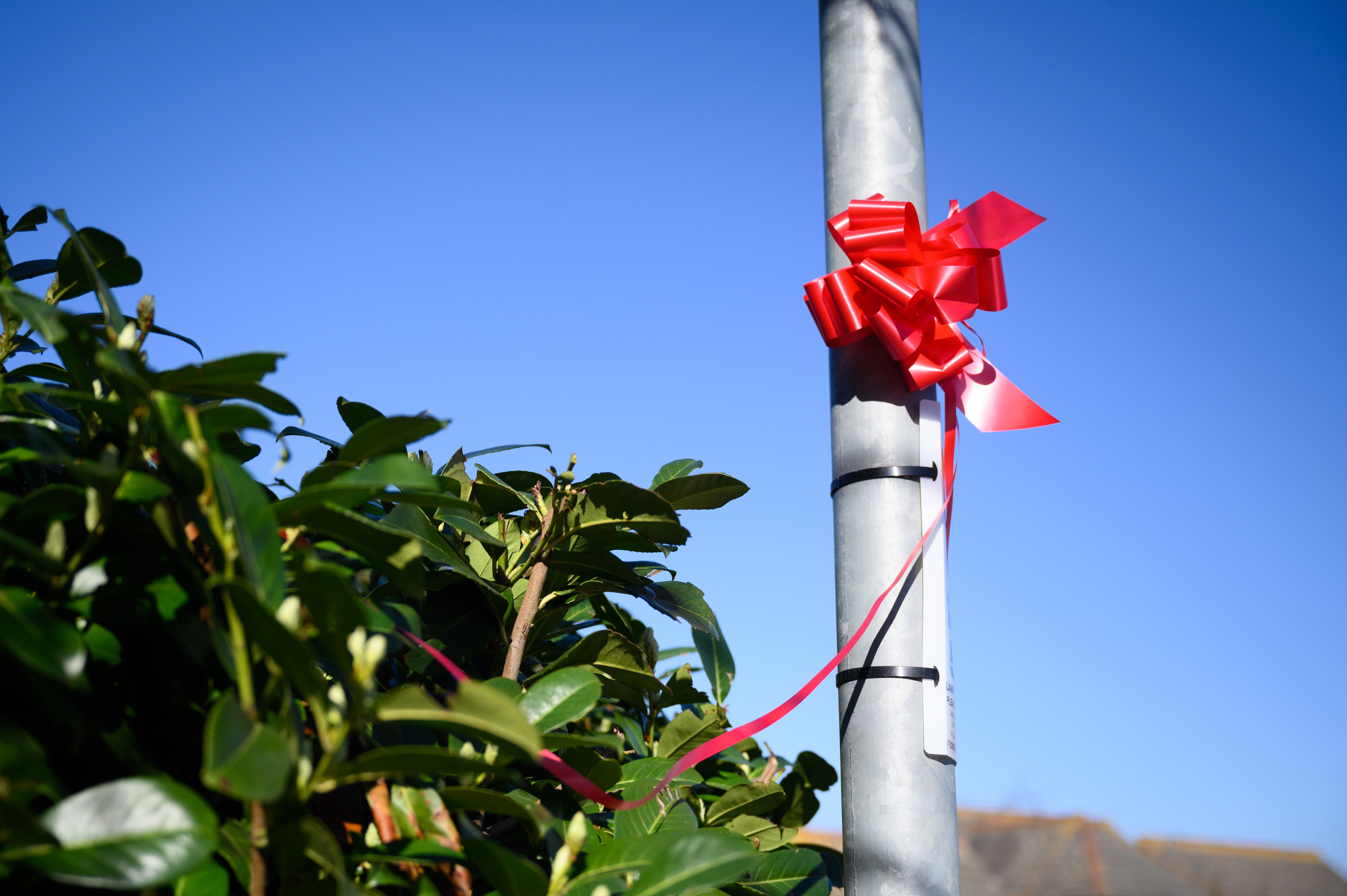 Red ribbons marked the route of the funeral procession