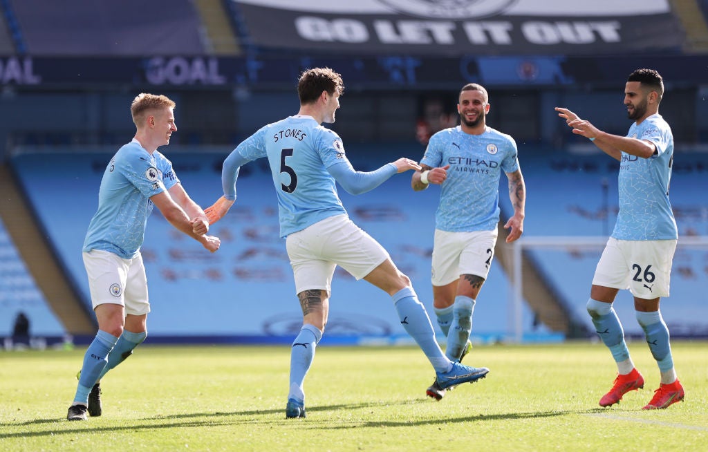 John Stones celebrates with team mates Kyle Walker, Riyad Mahrez and Oleksandr Zinchenko