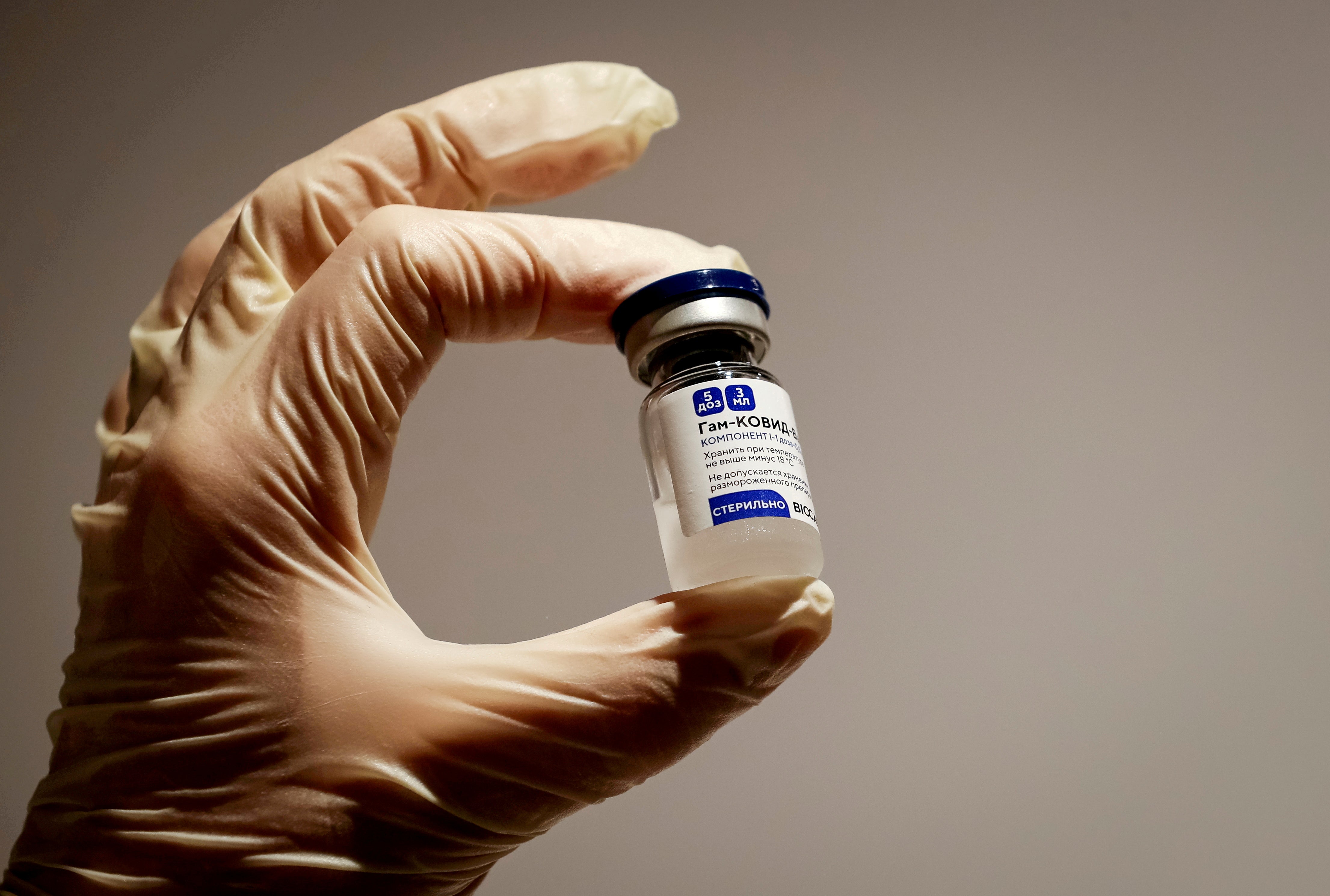 A medical specialist holds a vial of Sputnik V vaccine