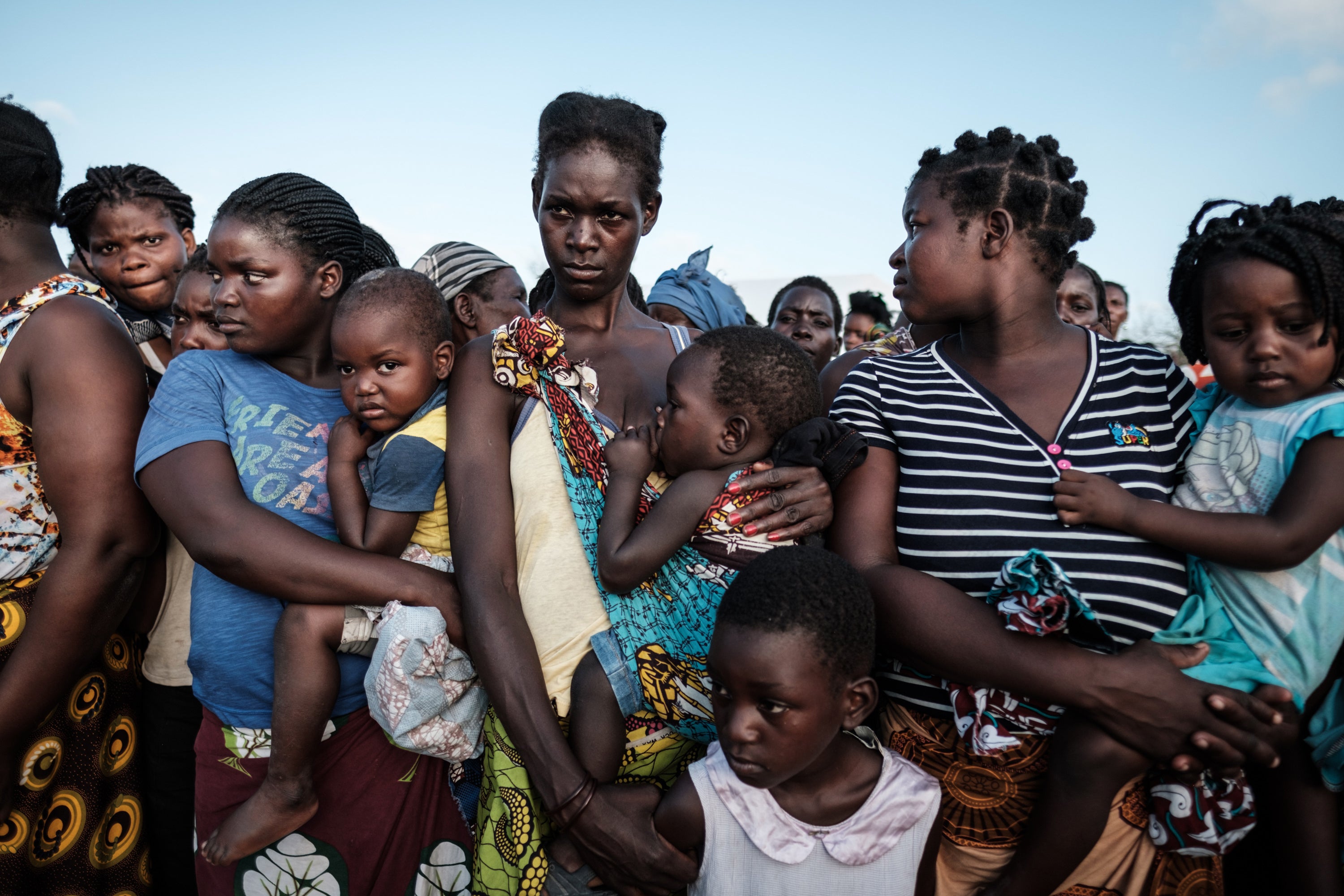 Mothers wait for food at an evacuation centre in Dondo, Mozambique. A cyclone ravaged the country in 2019, killing 468 people