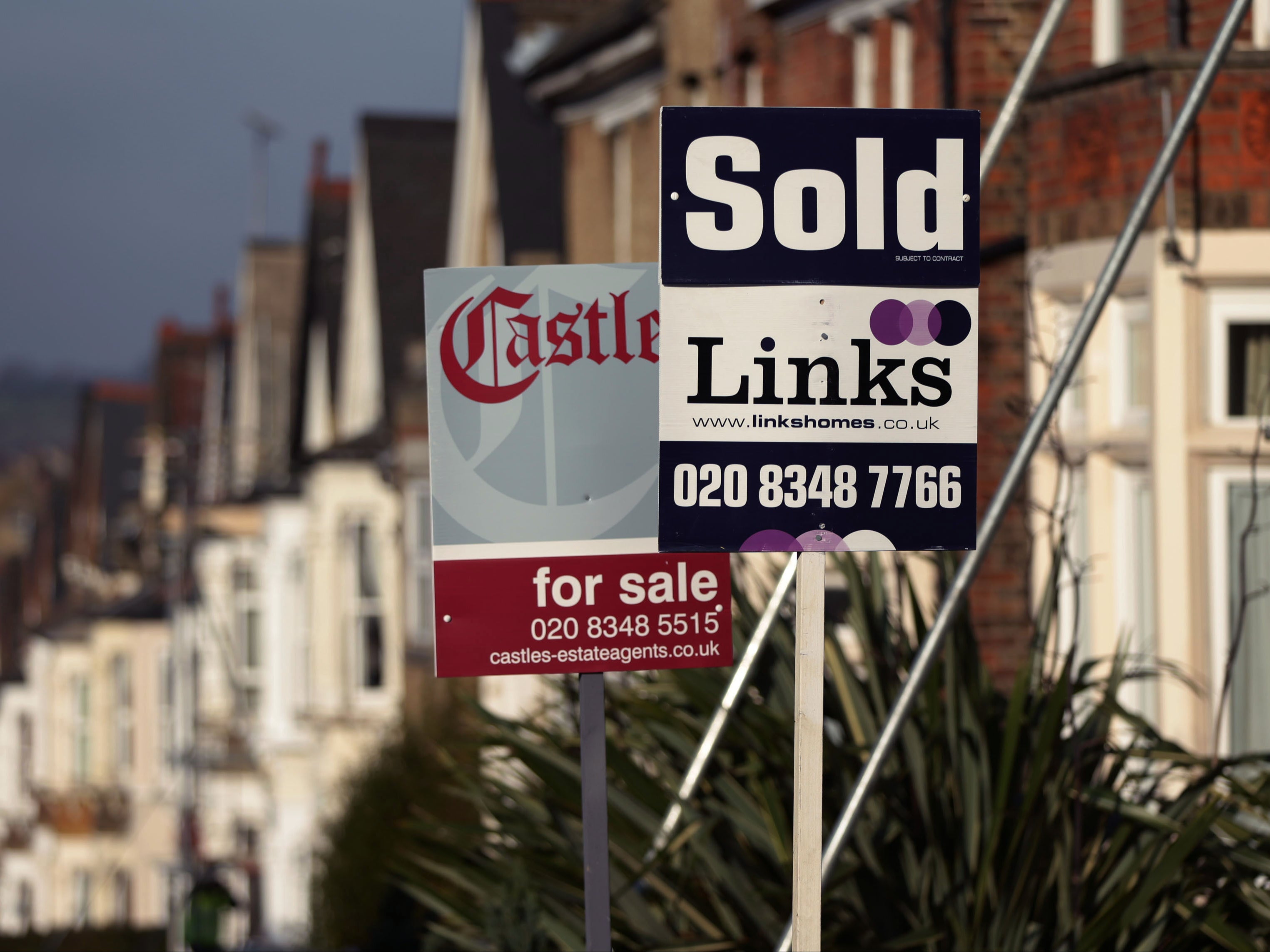 For Sale and Sold signs outside houses in north London