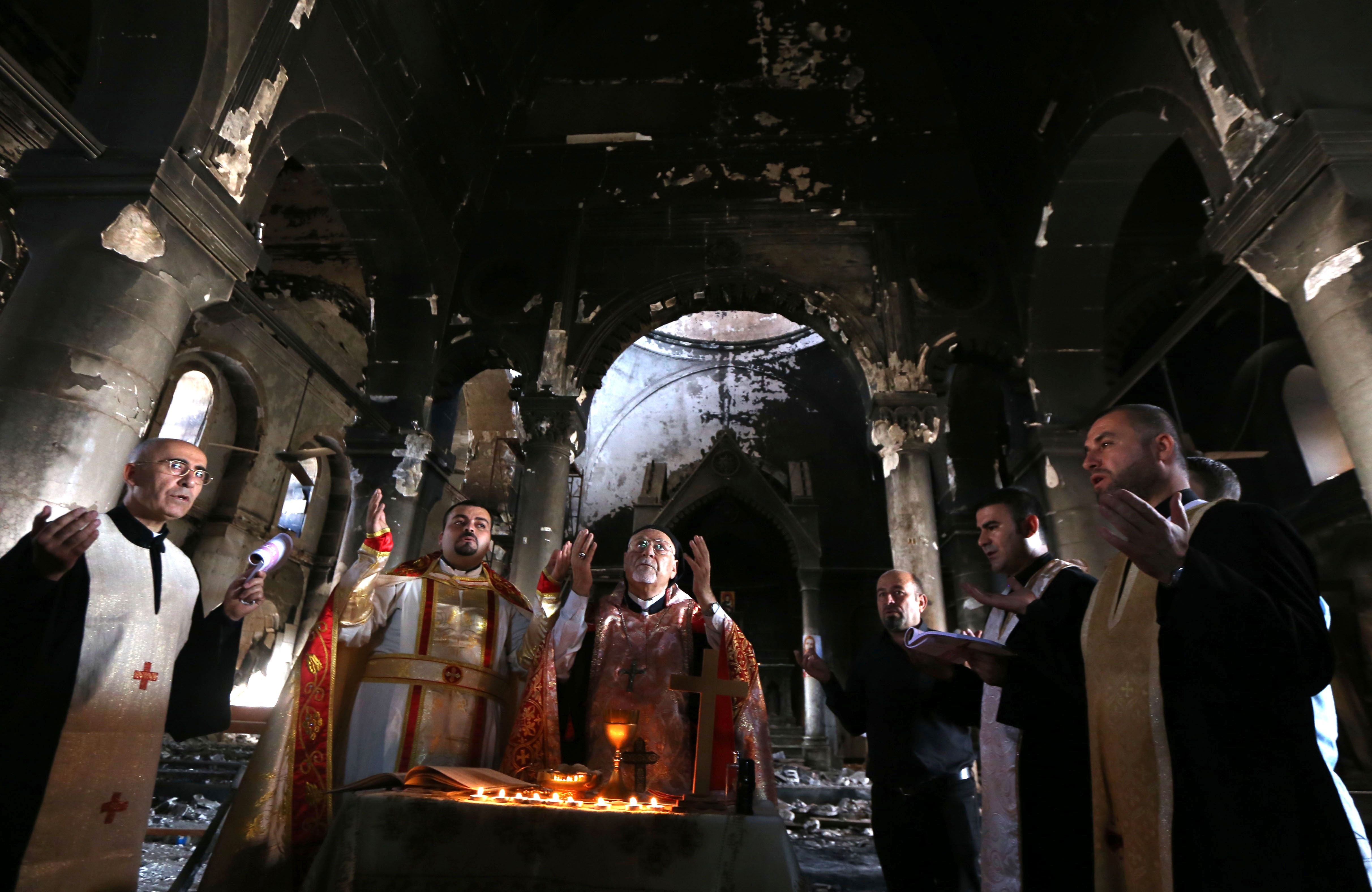 Archbishop Yohanna Petros Mouche leads a mass amid the ruins of the Immaculate Church in 2016