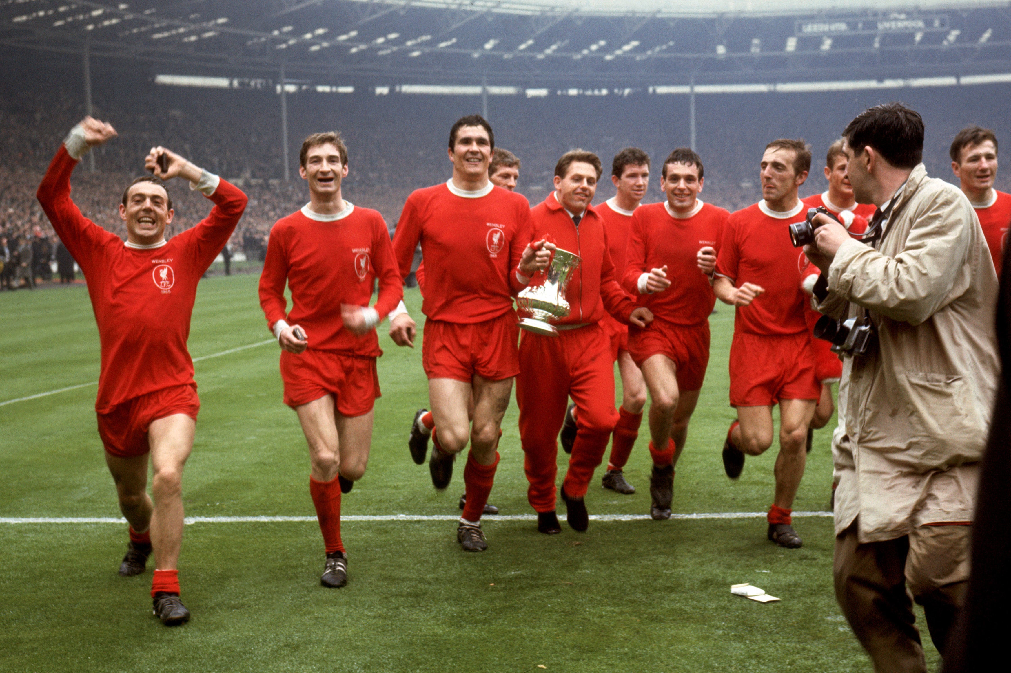 The Scot (left) celebrates winning the FA Cup with his Liverpool team-mates in 1965