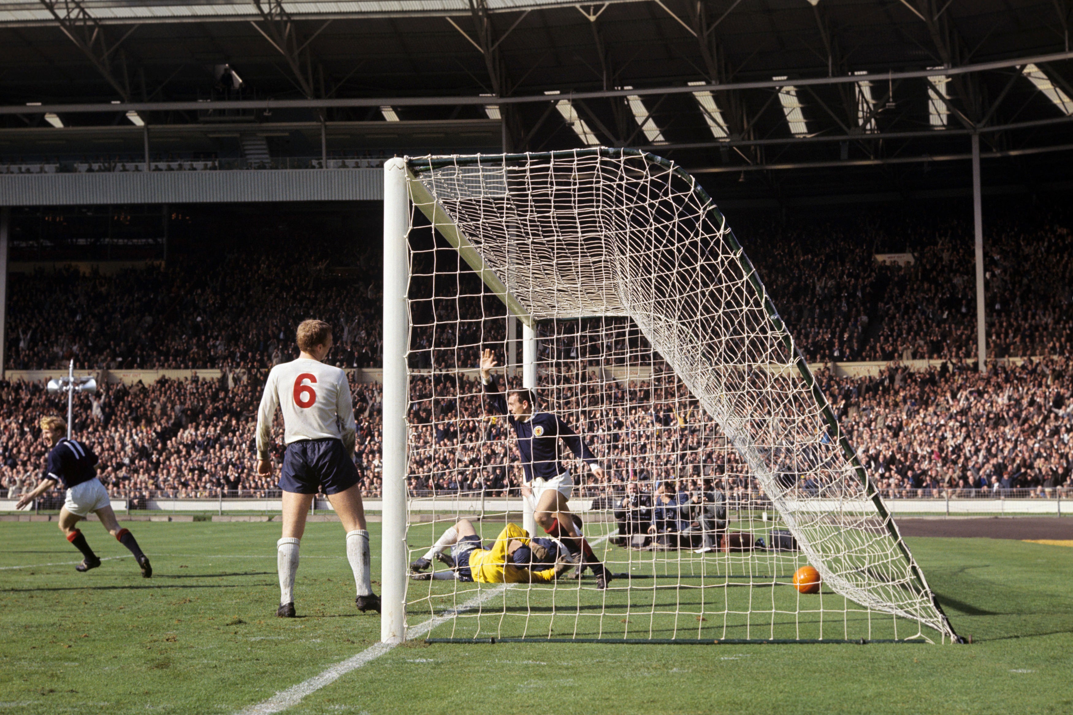 St John celebrates scoring against England at Wembley in 1965