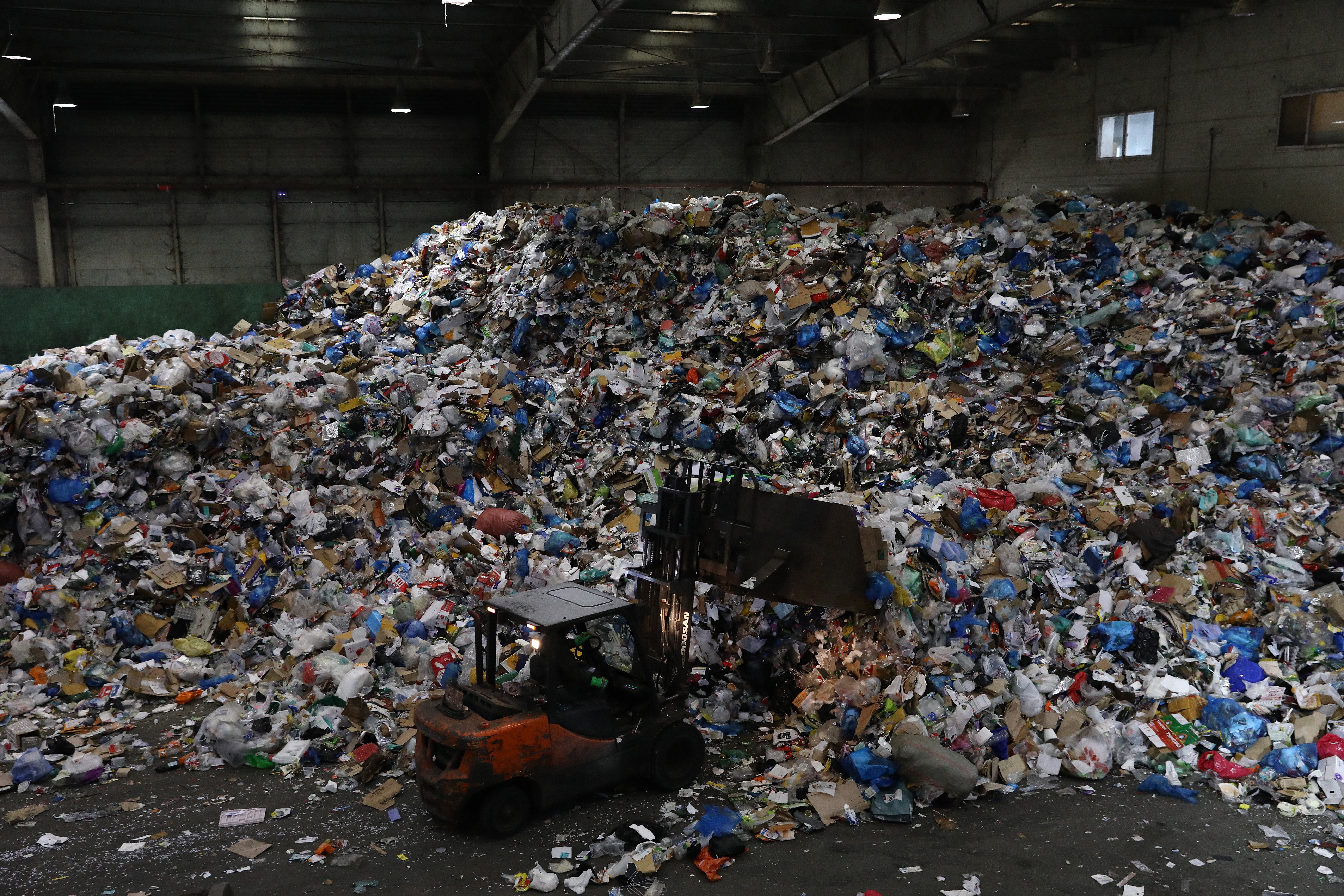 A forklift truck moves household waste at a facility in Seoul, South Korea