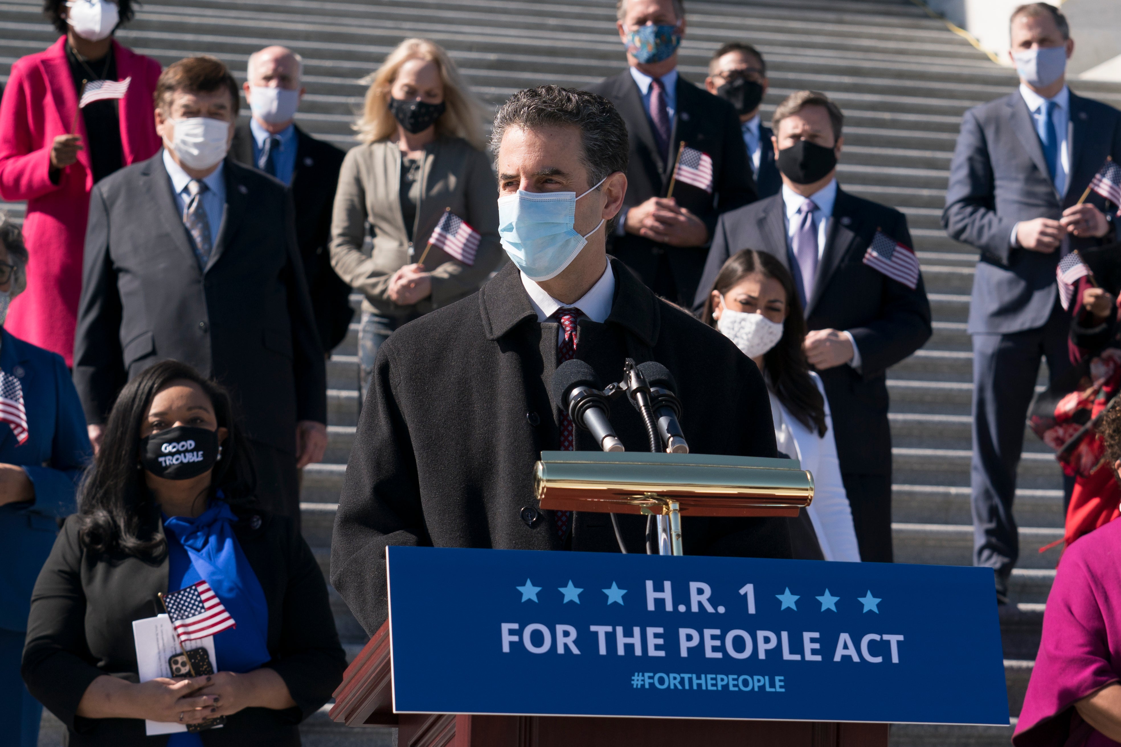 HR 1 sponsor John Sarbanes speaks with lawmakers ahead of a vote on the bill on 3 March.