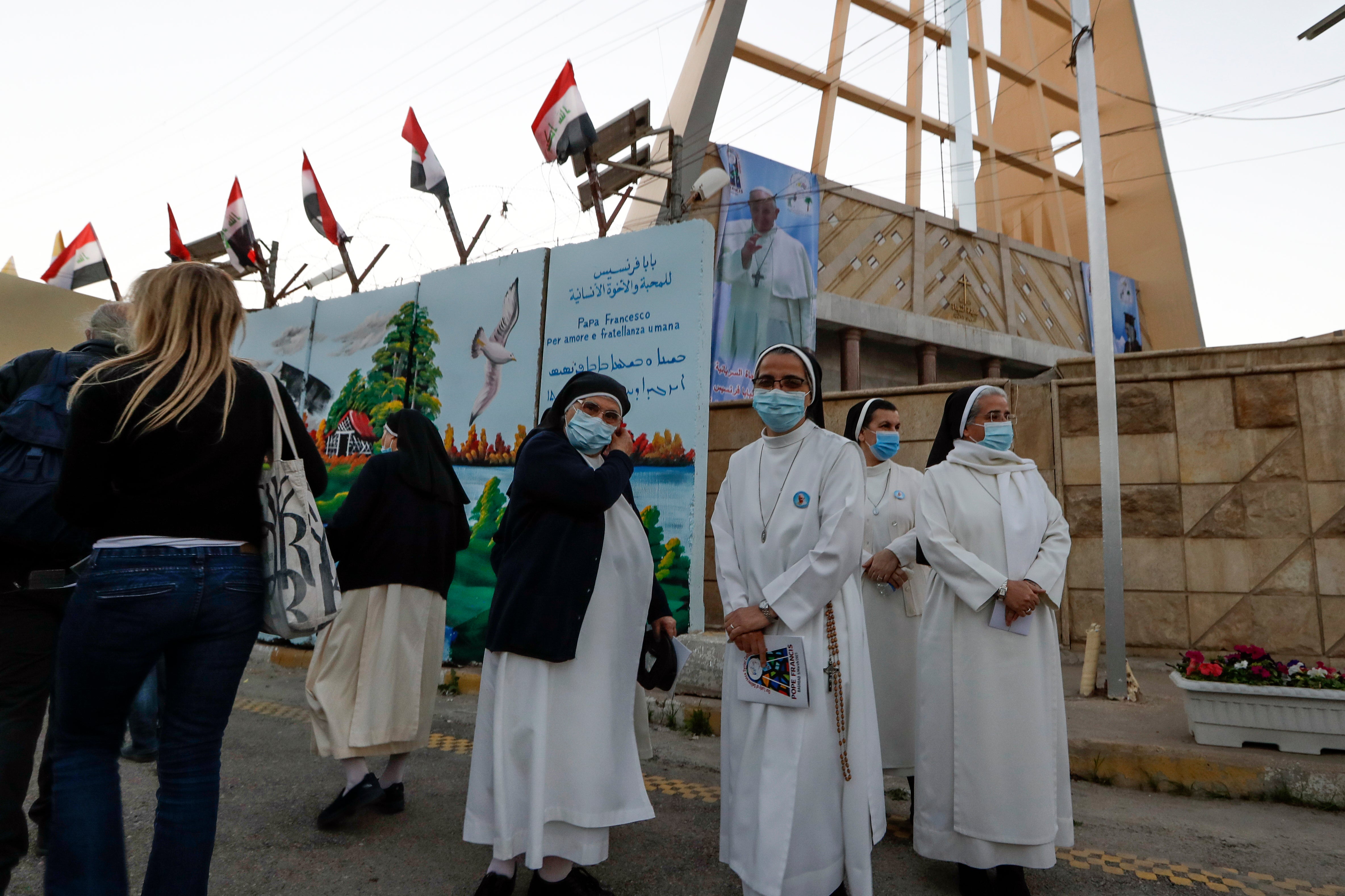 Nuns wait to see Pope Francis outside Sayidat al-Nejat (Our Lady of Salvation) church in Baghdad on Friday